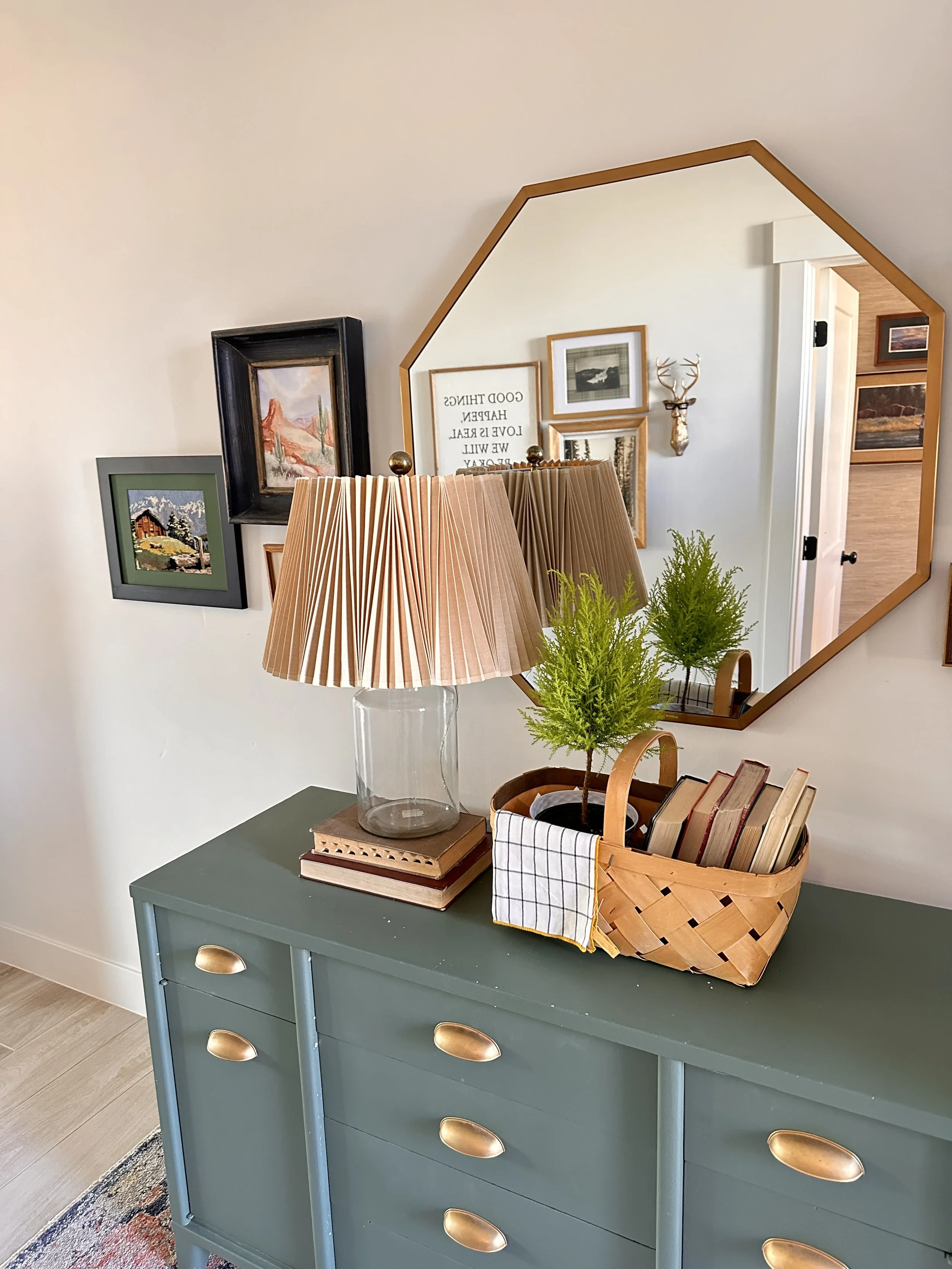 Green painted dresser with gold octagon mirror and framed gallery wall