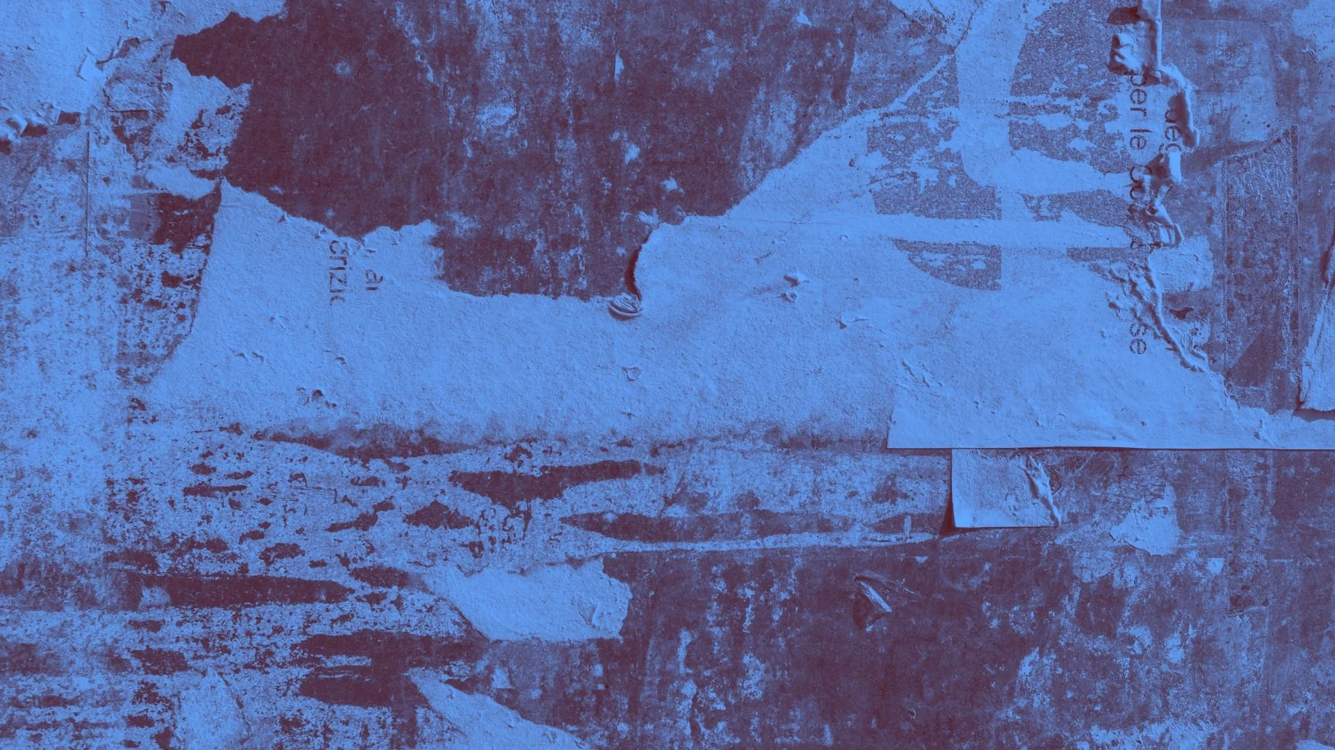 Detail of a worn and brushstroked wall with remnants of peeling paint and faded text, illuminated with a bluish tint, capturing textures and layered surfaces.