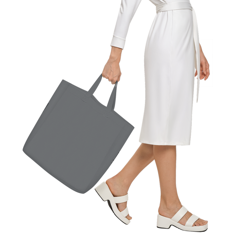 Woman of Ivory and Ebony grey art tote bag by Virginie Bergar — lifestyle view showing the bag carried by hand