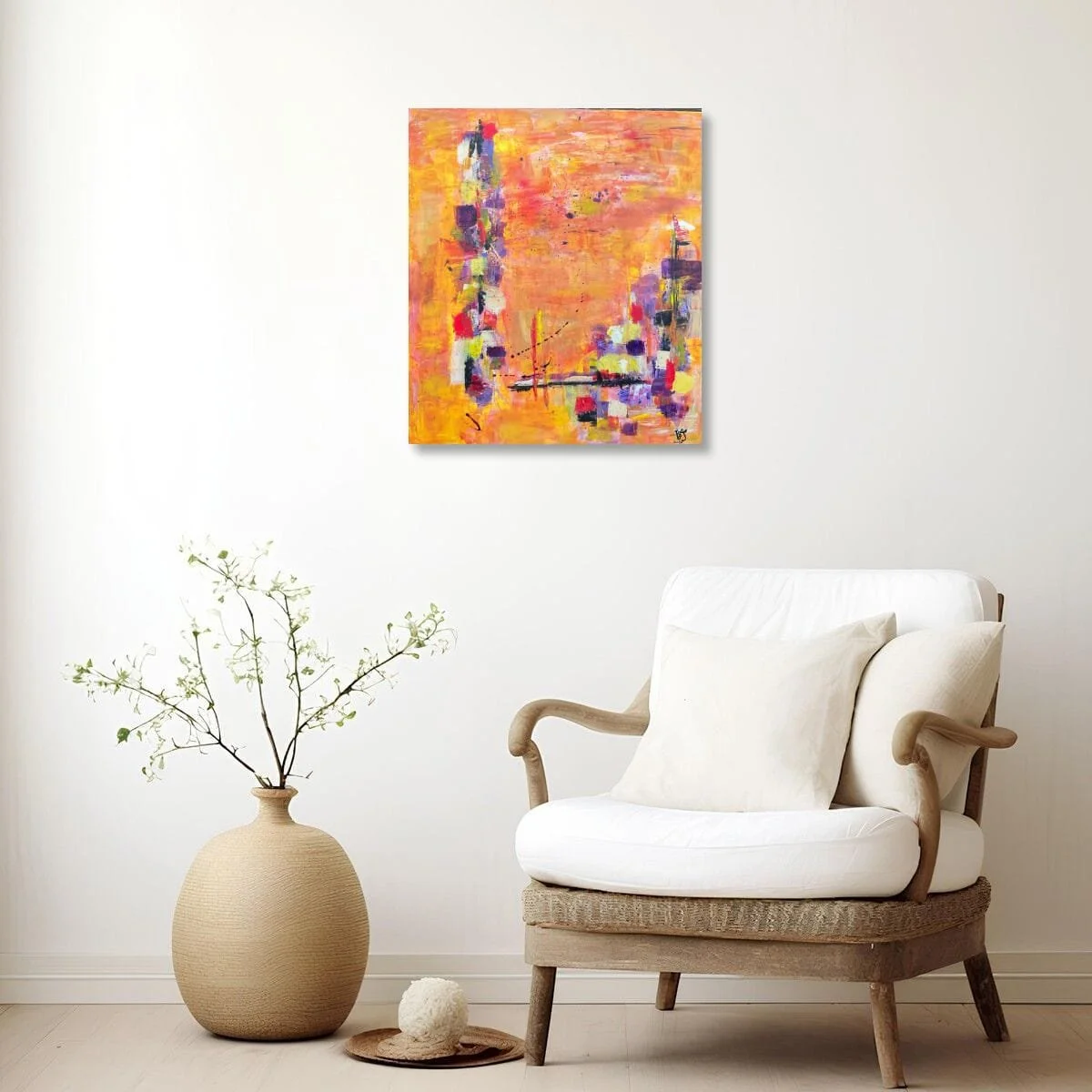 Incandescent Metamorphosis displayed in a calm neutral interior beside an armchair, showing how the vibrant painting creates a warm focal point.