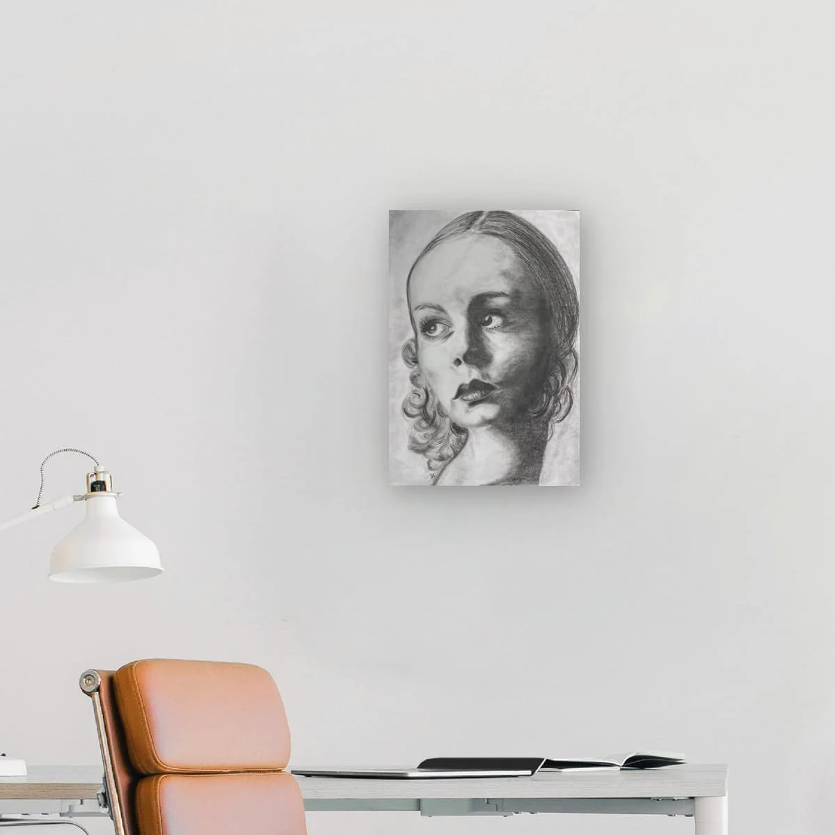 Where Time Falls Quiet displayed in a minimalist home office, original graphite portrait artwork by French artist Virginie Bergar.