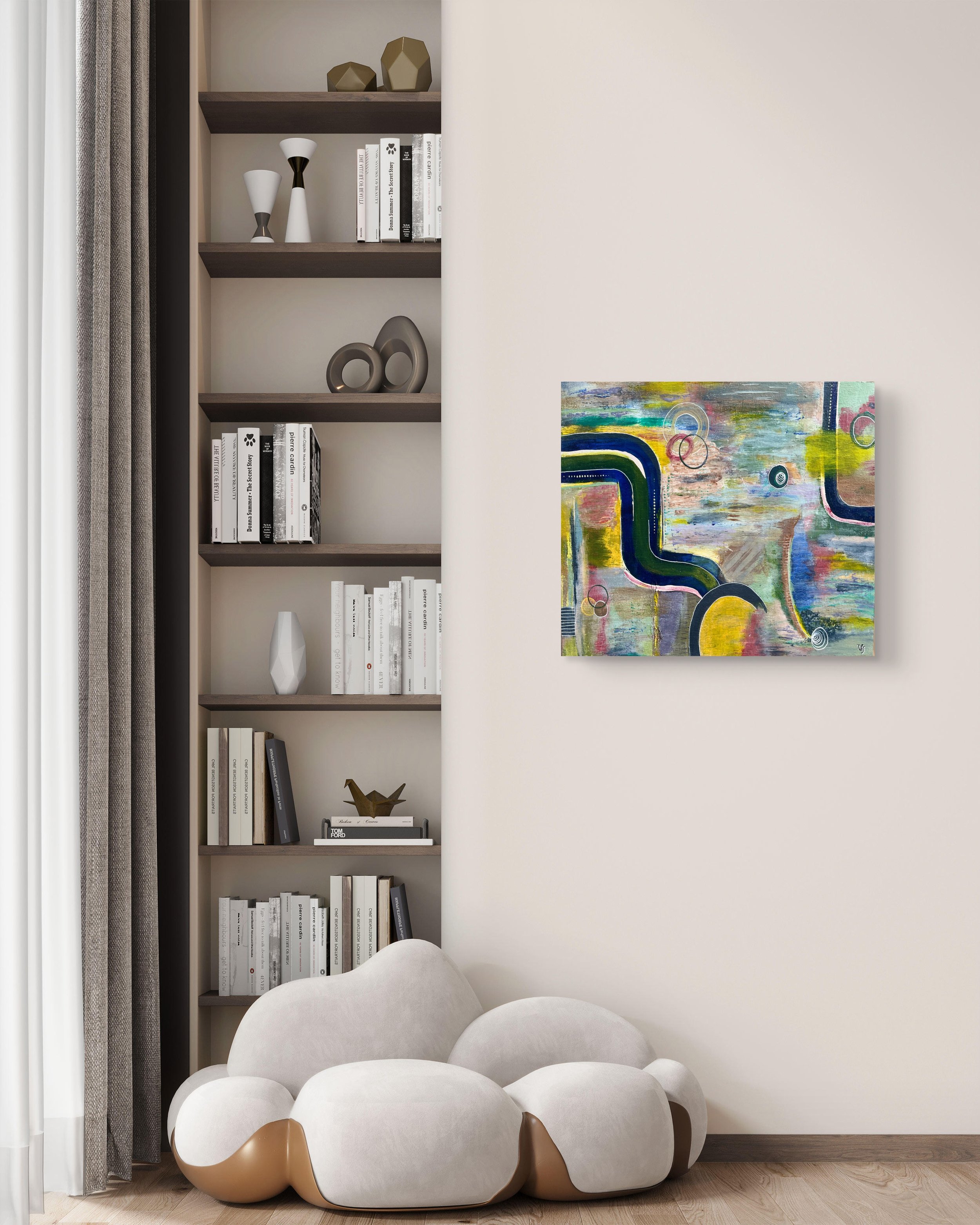 The Soul in Colour displayed beside a sculptural armchair and shelving in a contemporary reading corner, original artwork by Virginie Bergar.