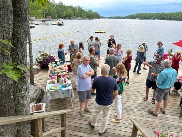 Cocktail party on the dock, with members of the Lakeshore Drive Community Association meeting their neighbours in happy discussion