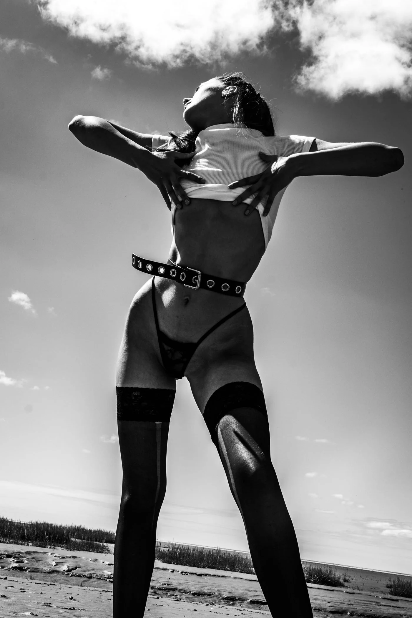 Black and white windswept coastal fashion portrait from the Unfiltered fashion photography series by CAMR Visuals