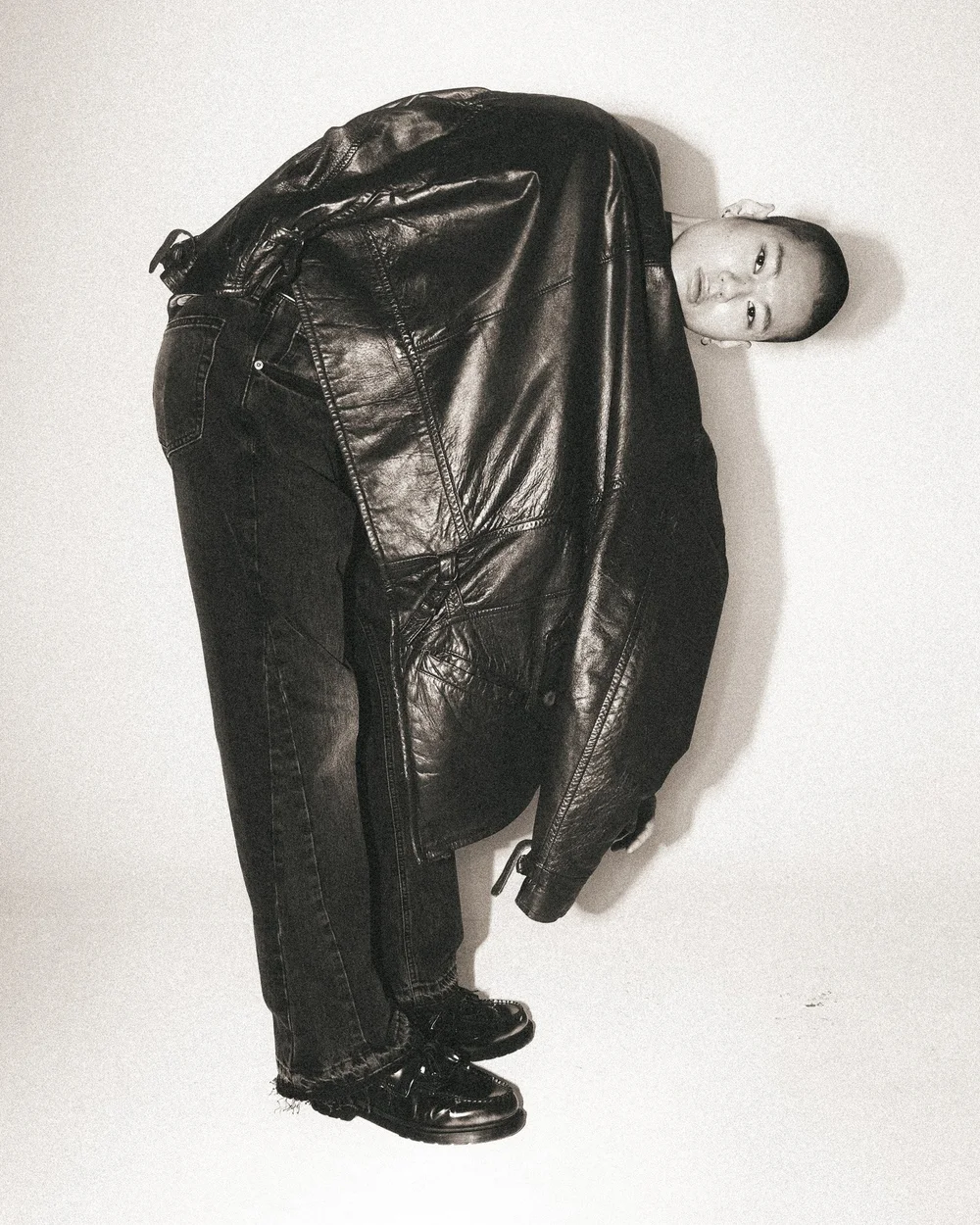 Oversized quilted black leather jacket, sculptural studio pose. Photography by CAMR Visuals.