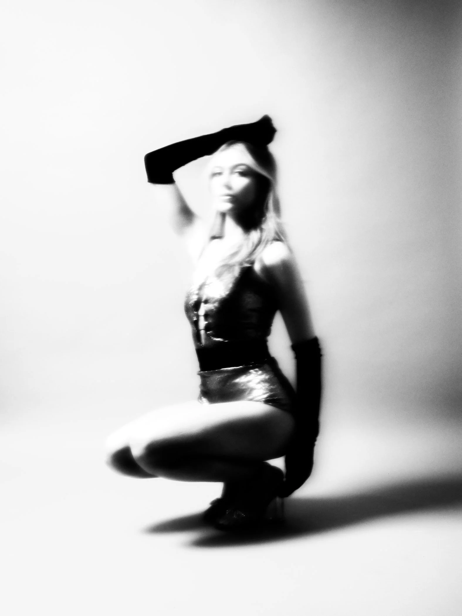 Black and white avant garde seated pose from the Unfiltered fashion photography series by CAMR Visuals