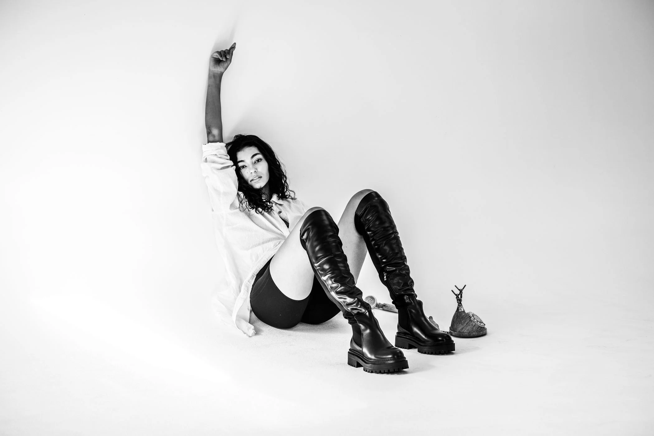 Black and white seated ankle boot studio portrait from the Unfiltered fashion photography series by CAMR Visuals