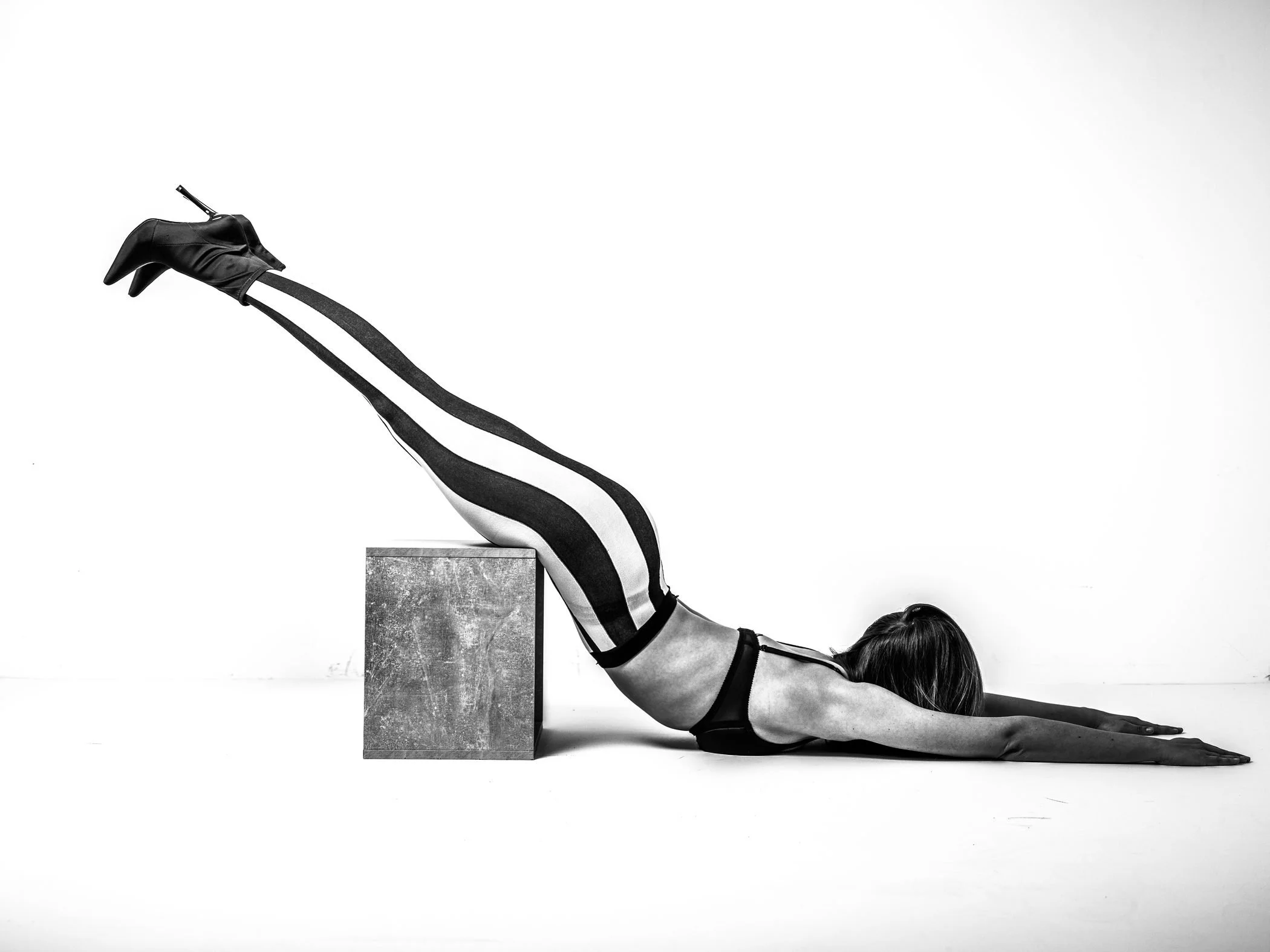 Black and white extended leg geometric pose from the Unfiltered fashion photography series by CAMR Visuals