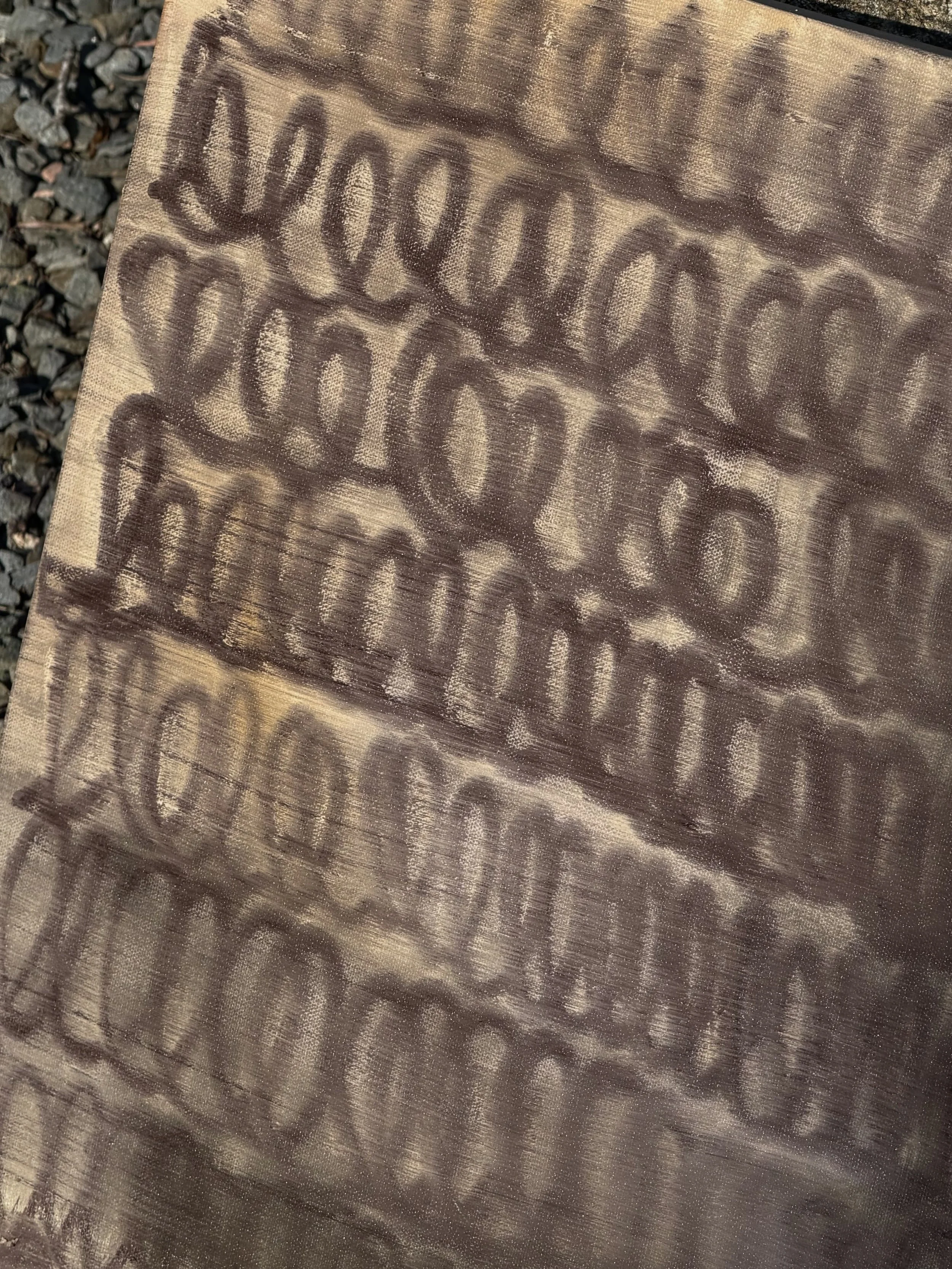 A wooden surface with engraved or burned text reading "You are enough" in a cursive font.