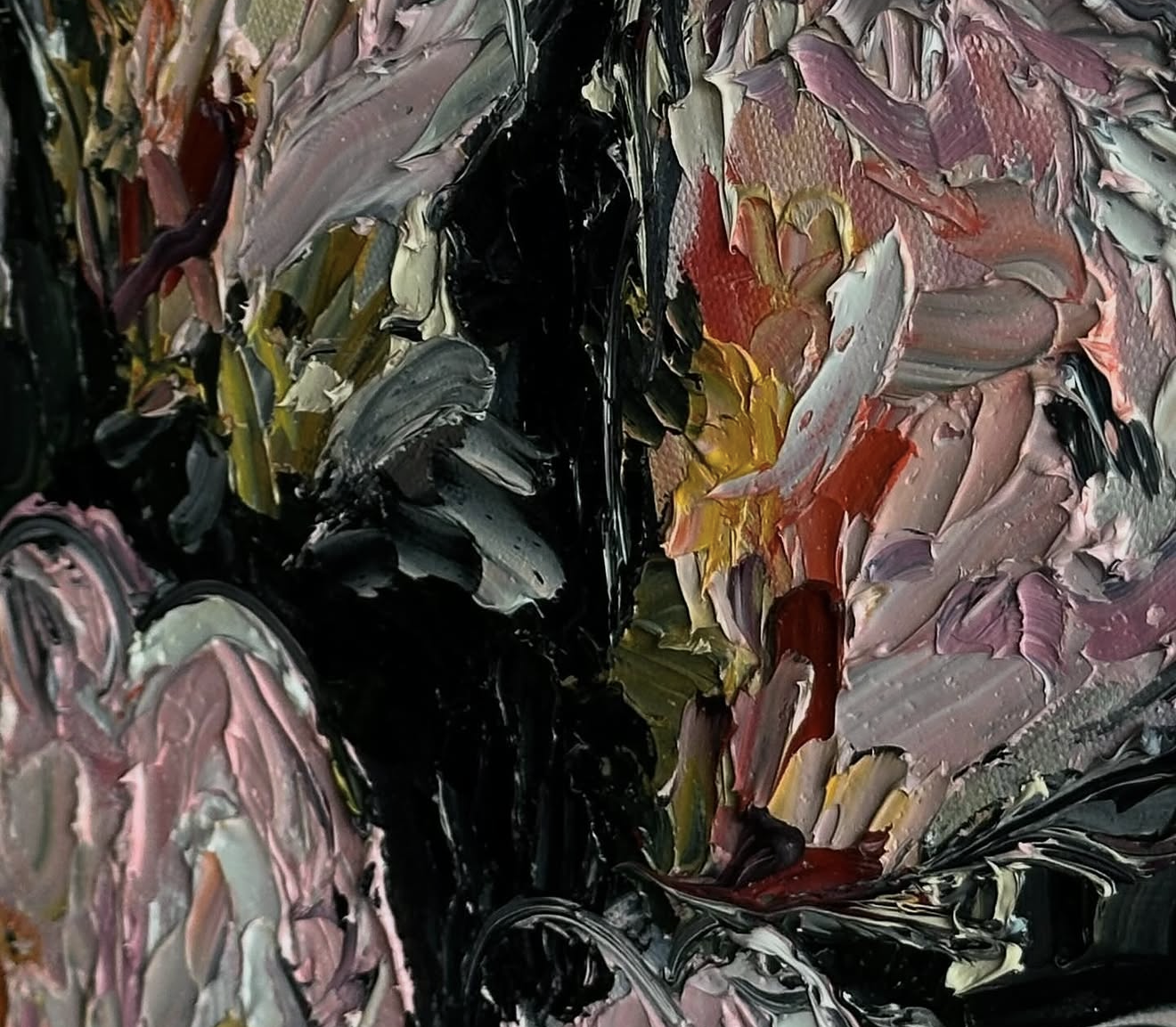 Close-up of an abstract oil painting with thick, textured strokes in colors including black, pink, red, yellow, purple, and white.