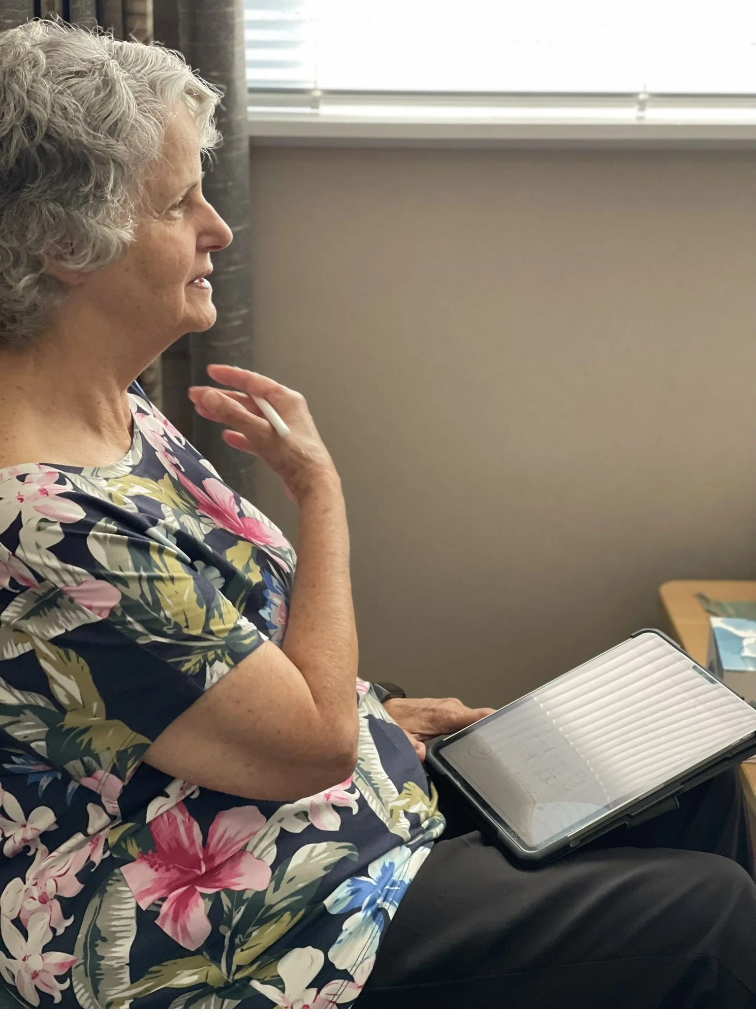 Older woman reflecting and writing in a journal during a supportive counselling session, representing counselling for abuse, trauma and emotional wellbeing in a safe, confidential and compassionate space for healing and recovery