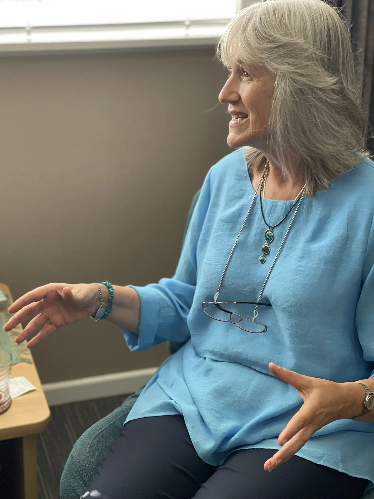 Woman counsellor demonstrating a breathing technique during a counselling session at Pakuranga Counselling Centre in East Auckland