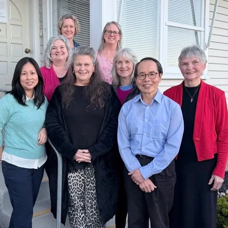 8 Pakuranga counselling centre counsellors standing in front of a beige door and windows with white blinds