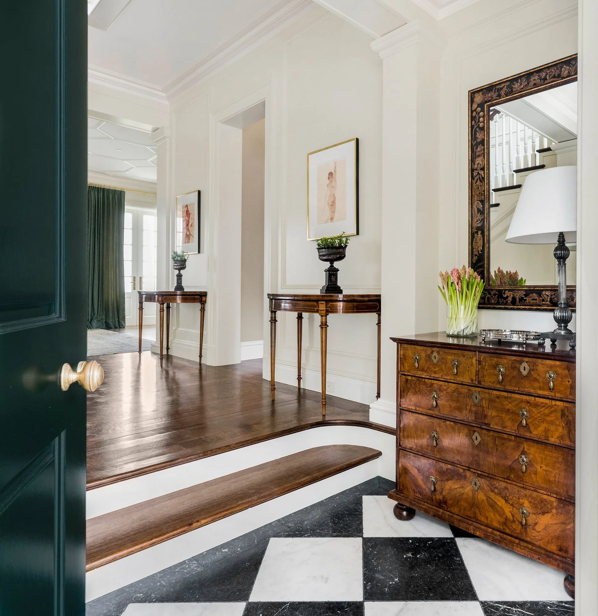 Entry vestibule with dark green door, checkerboard marble floor, and antique chest, East Coast Georgian