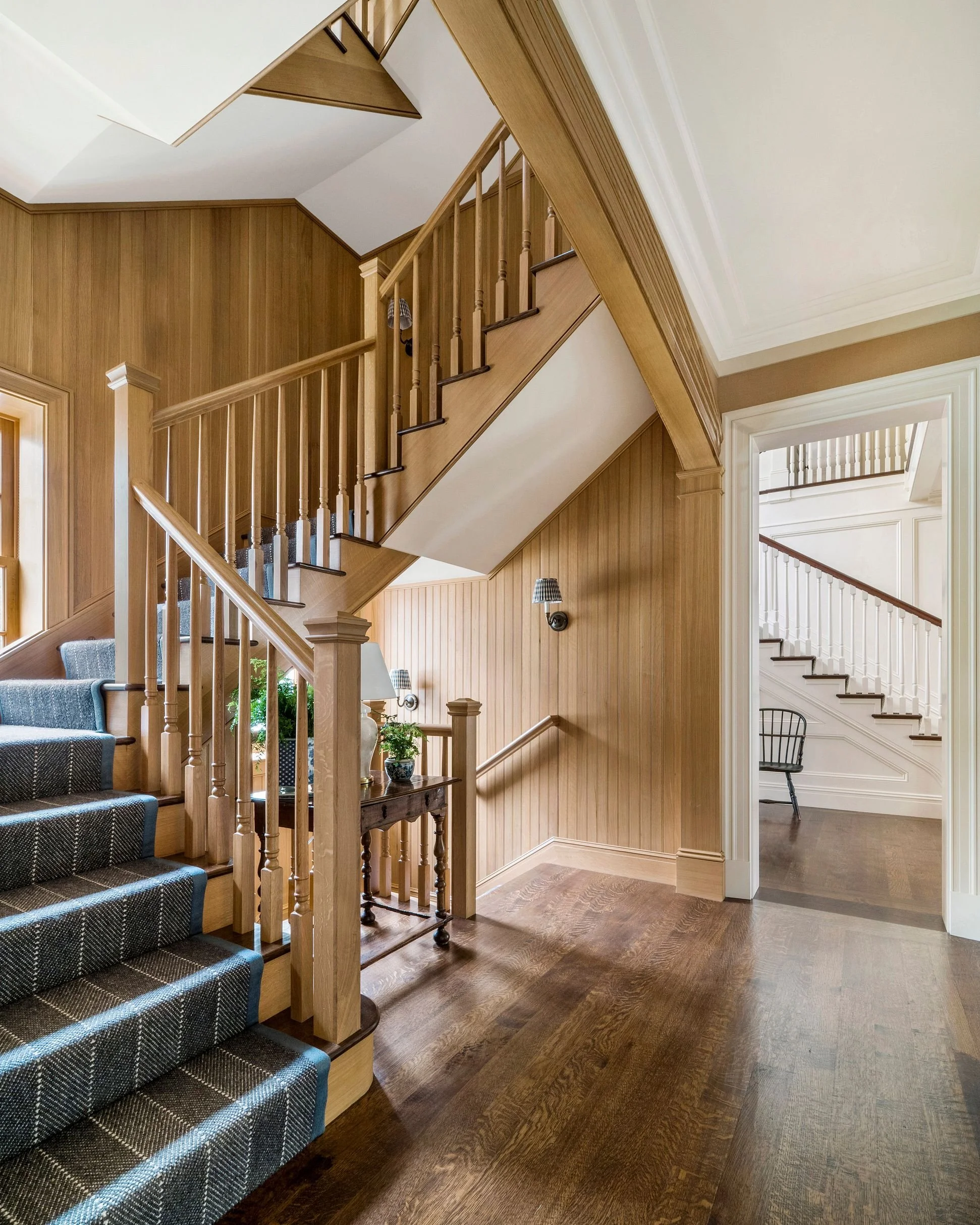 Wood-paneled back staircase with patterned runner, East Coast Georgian