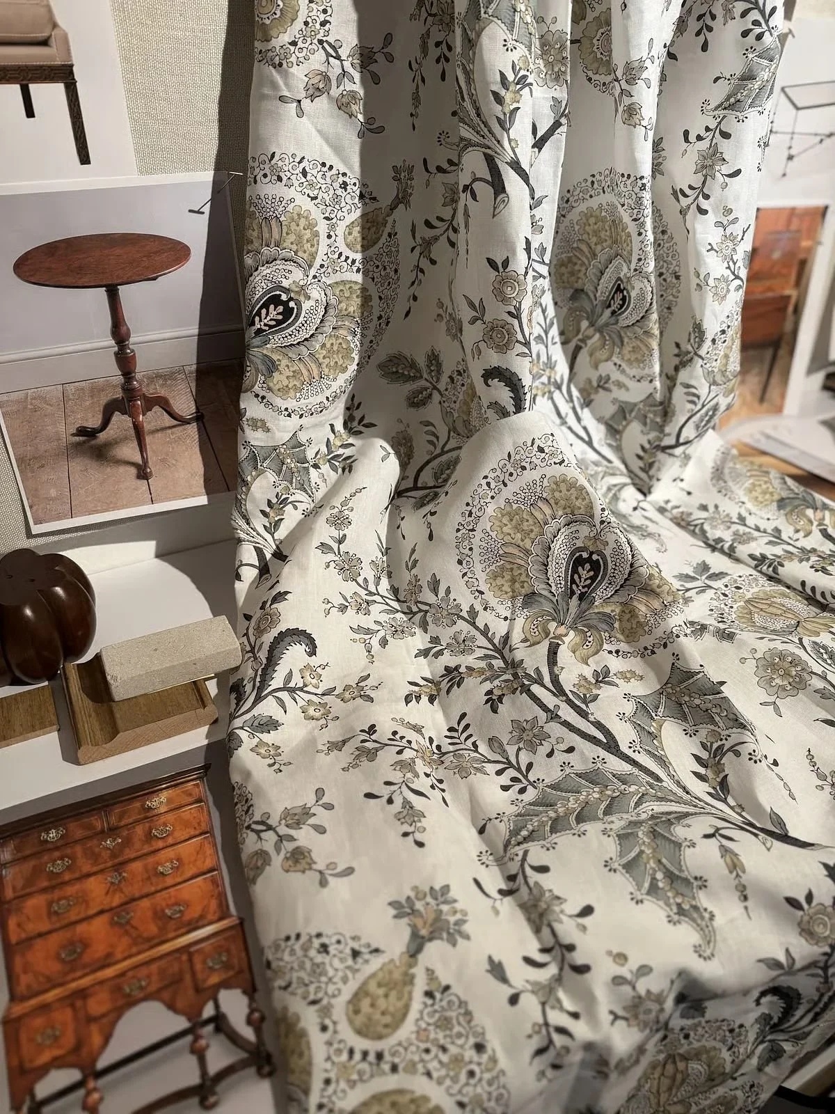 Embroidered floral fabric draped over an antique chair