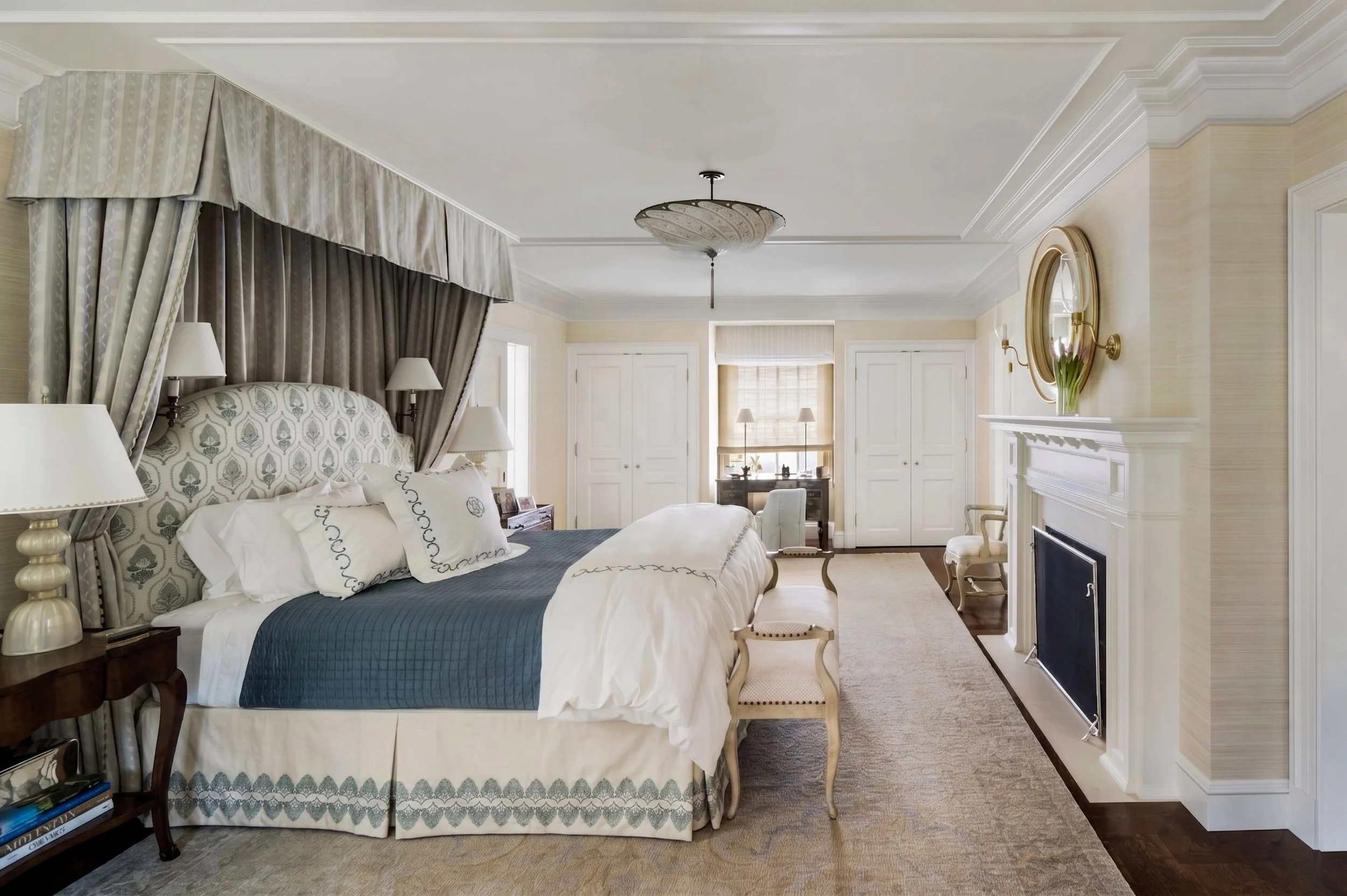 Primary bedroom with canopy bed, fireplace, and pale blue drapery, East Coast Georgian