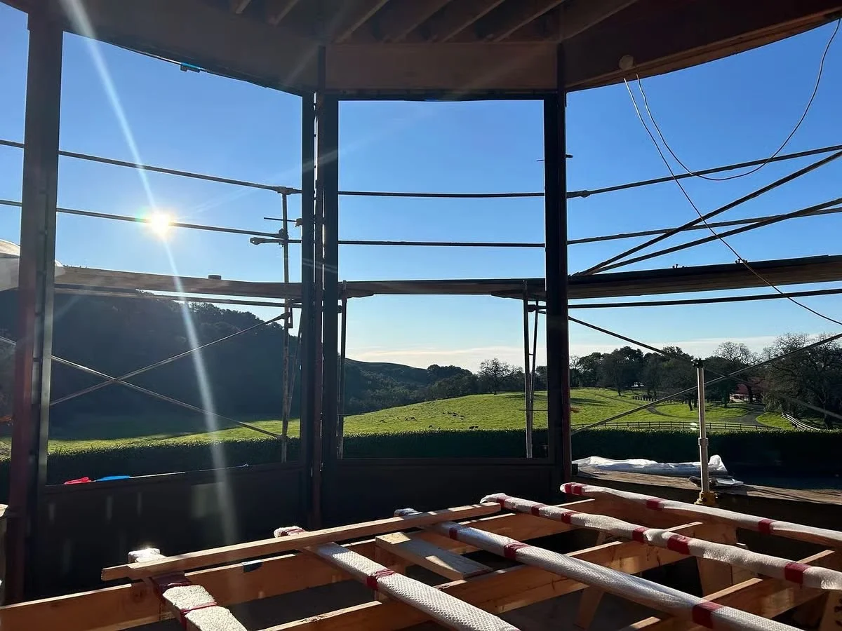 Framed window wall at a construction site with view over the landscape