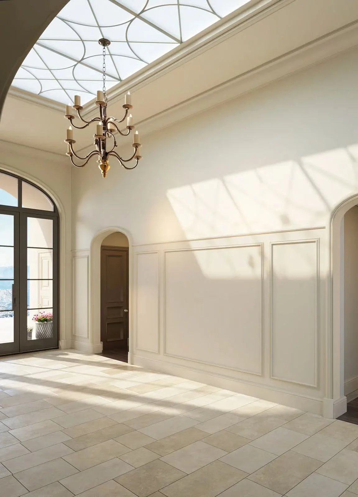 Sunlit entry hall under construction with skylight, iron chandelier, and paneled walls, project in progress