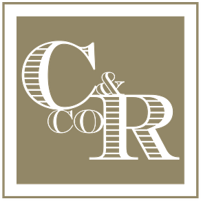 Gold-colored logo with the words 'C & R' inside a square frame