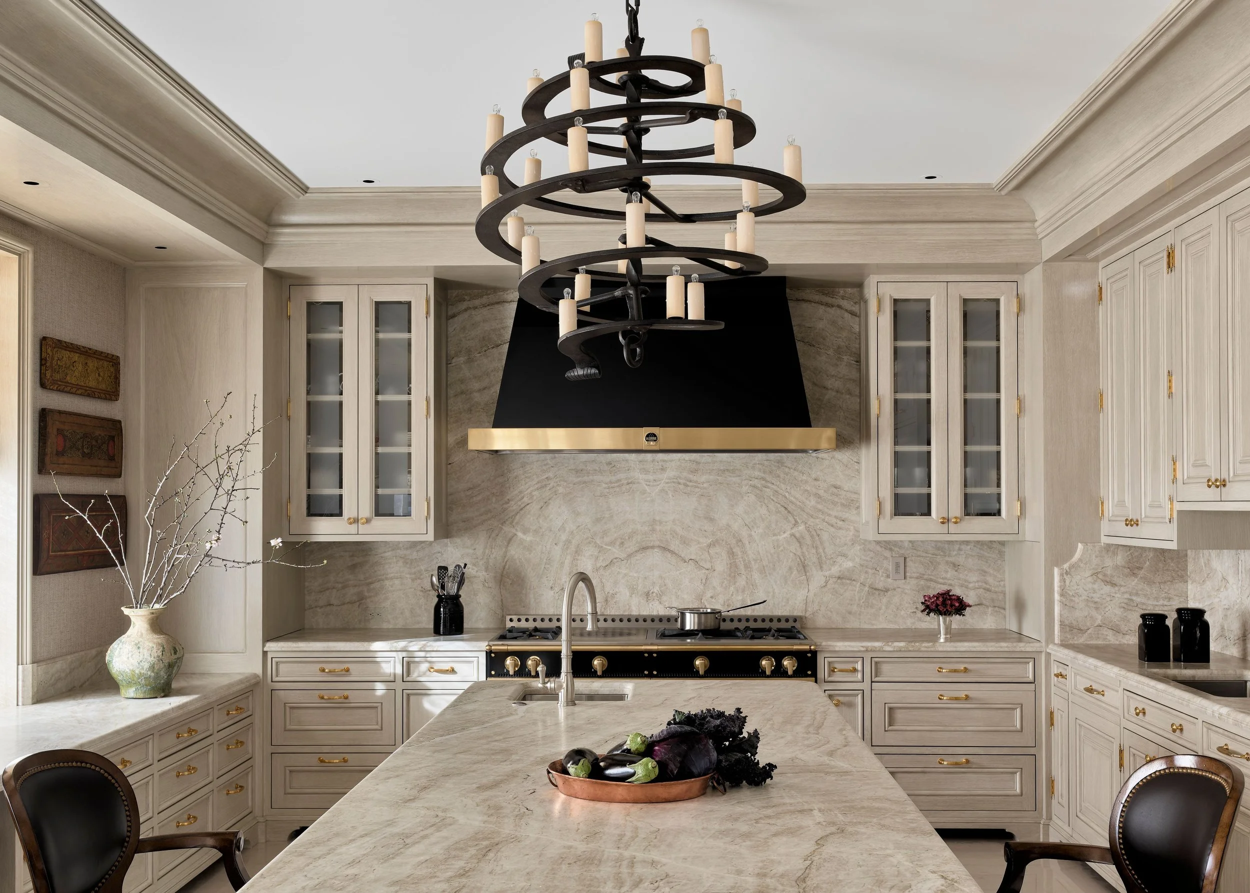 Kitchen with marble island, black range hood, and iron chandelier, Classic French Apartment