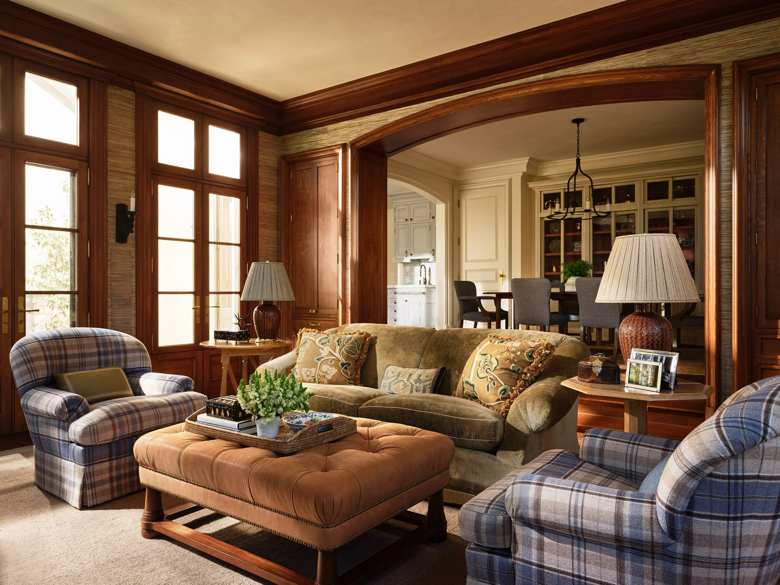 Family room with beamed ceiling, tufted leather ottoman, and plaid armchairs, Hillsborough Estate