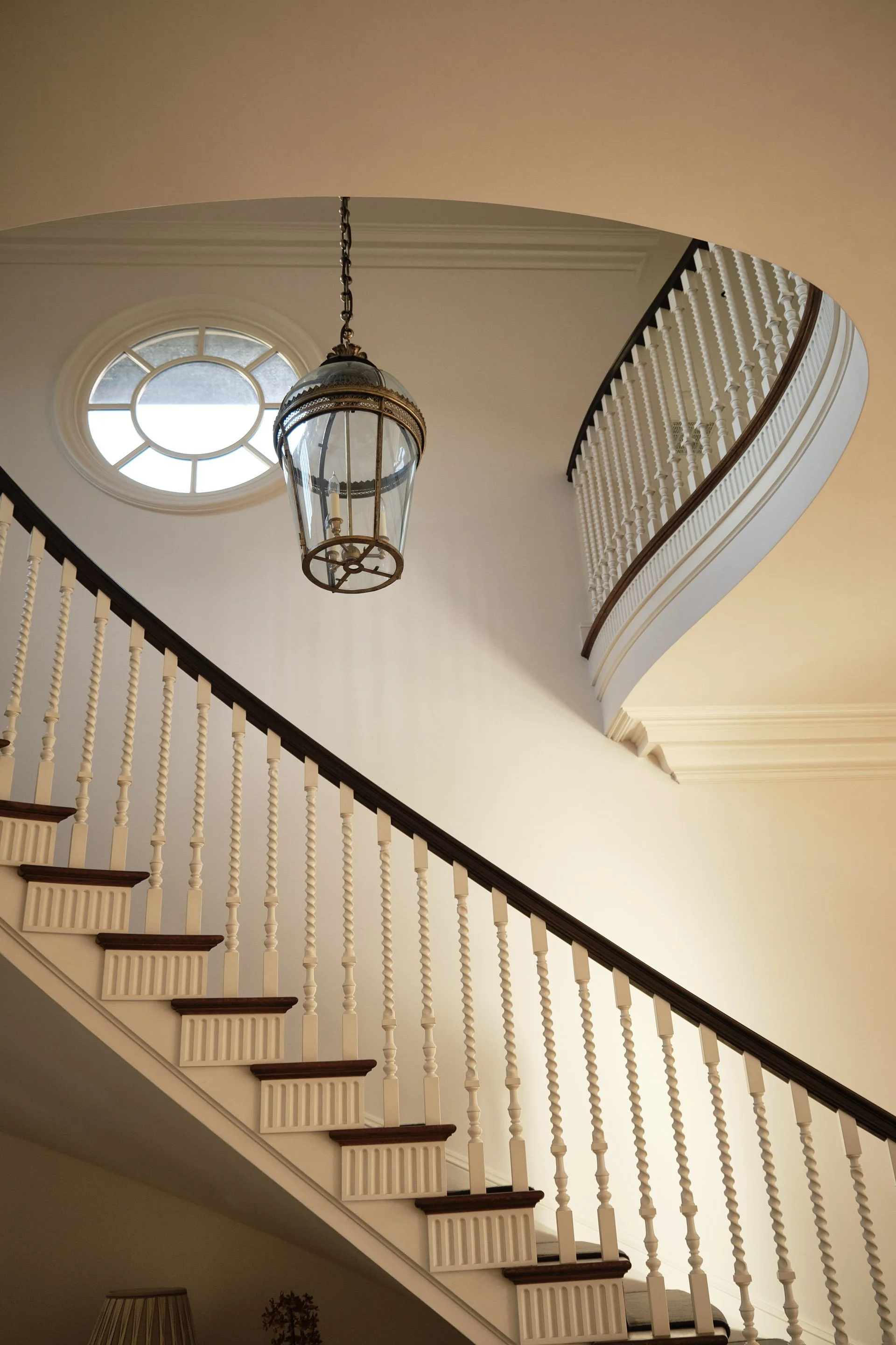 Curved staircase with pendant lantern and round window, Hillsborough Estate
