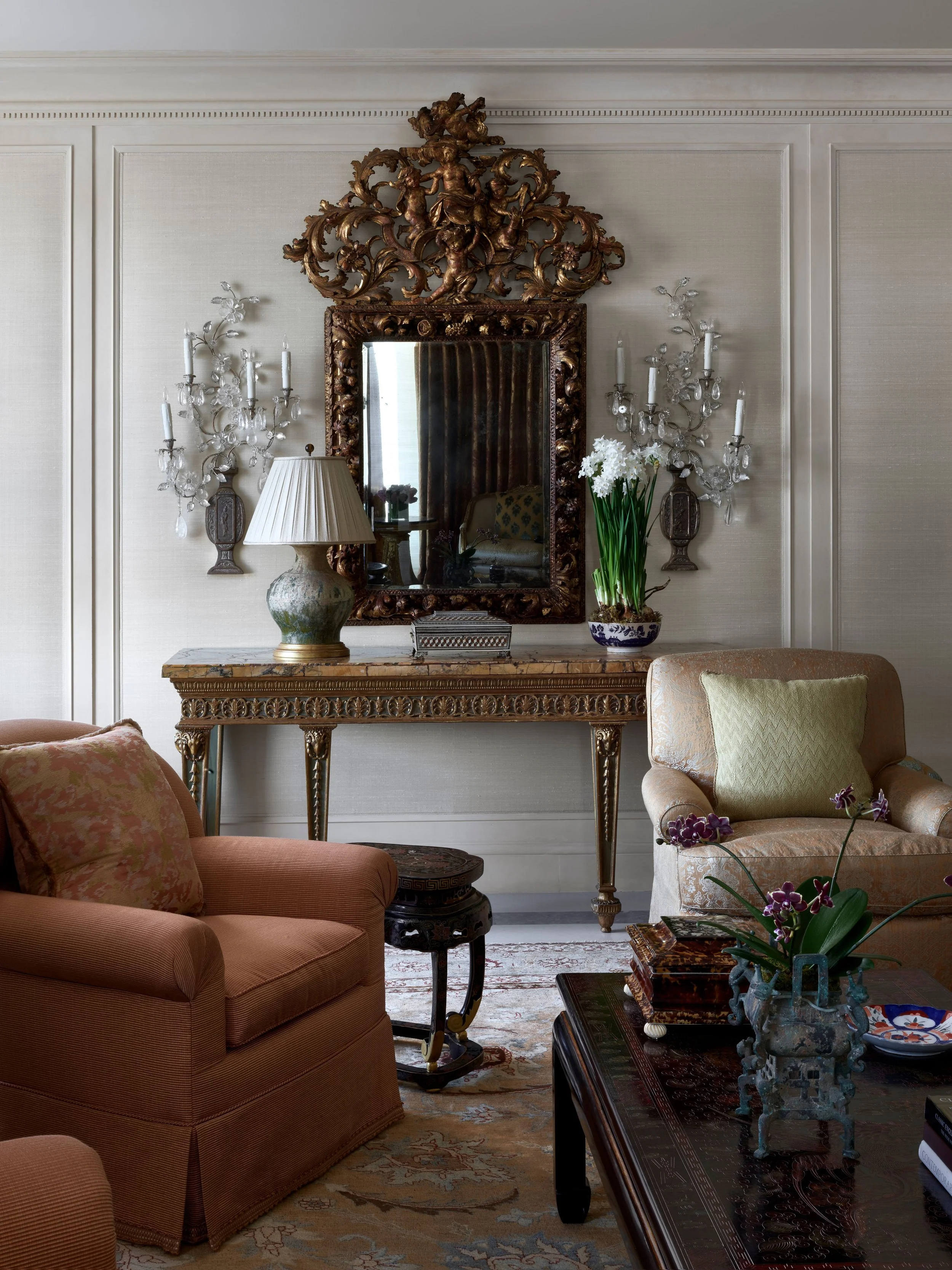 Living room with gilt mirror, crystal sconces, and silk-covered walls, Classic French Apartment