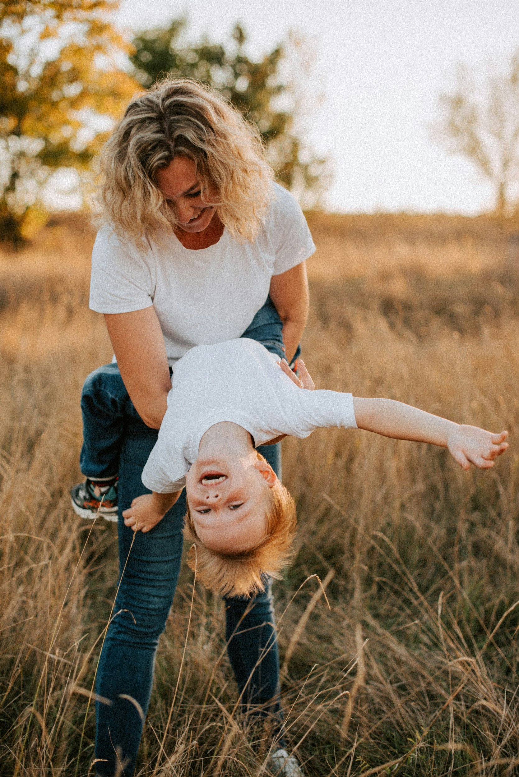 Mother sharing a playful moment with her energetic child, reflecting the love, overwhelm, and uncertainty parents may experience while learning how to support a child with ADHD or autism.