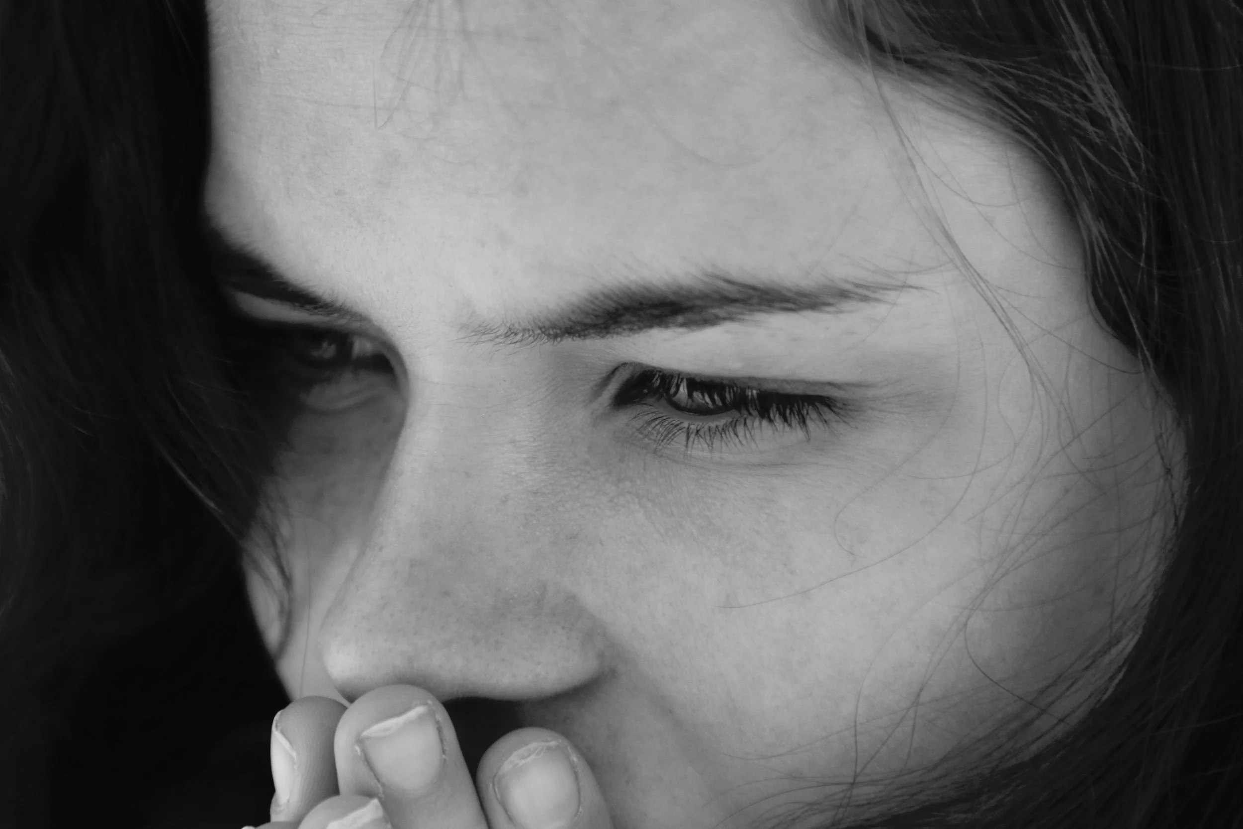 A young woman looking out at the world, reflecting the internal experience of being autistic while navigating a predominantly neurotypical world, where differences in how she experiences, processes, and understands things may not always be visible