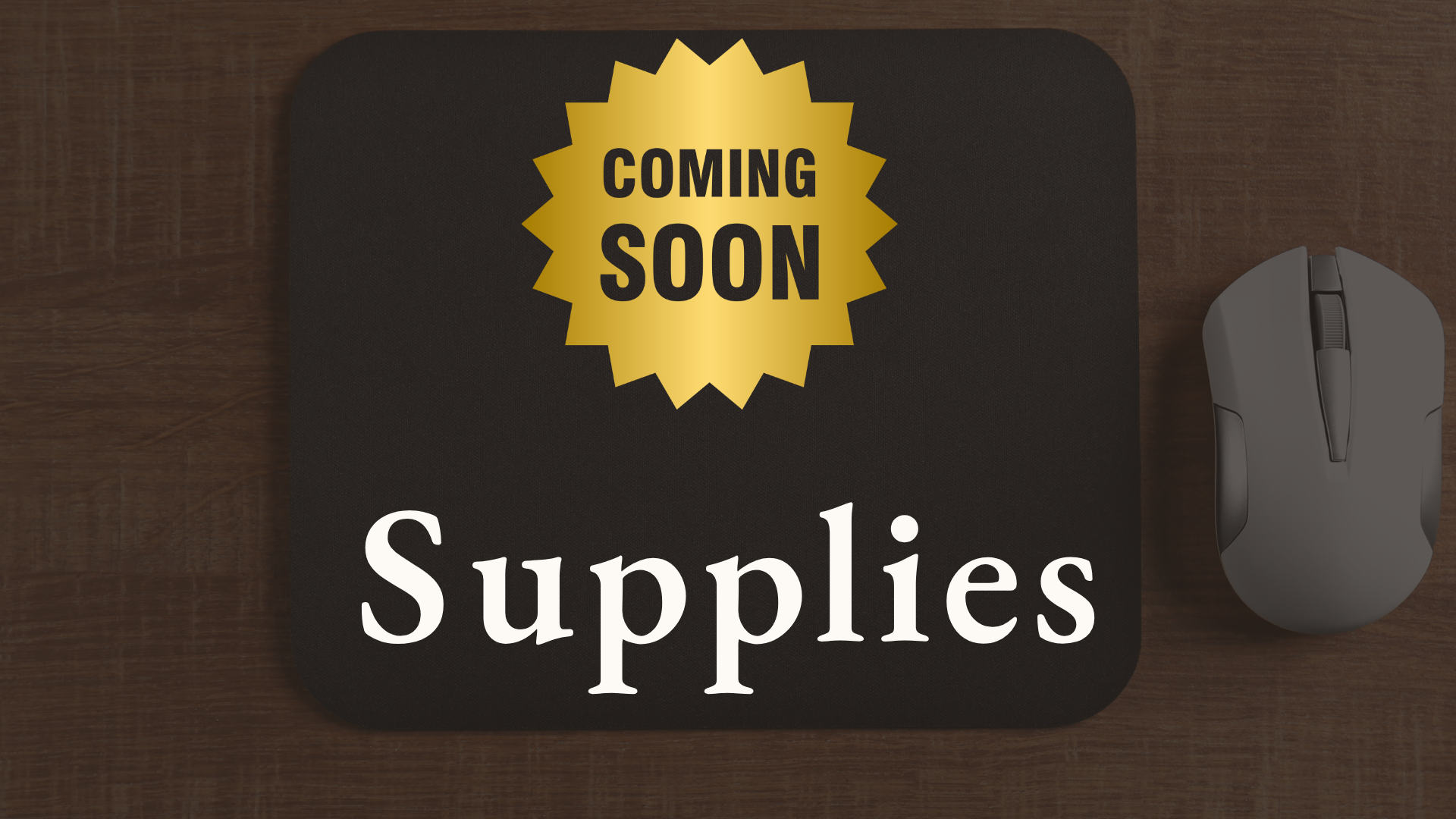 A sign on a black clipboard that reads "Supplies" and a yellow starburst sticker that says "Coming Soon" on a wooden desk with a computer mouse to the right.