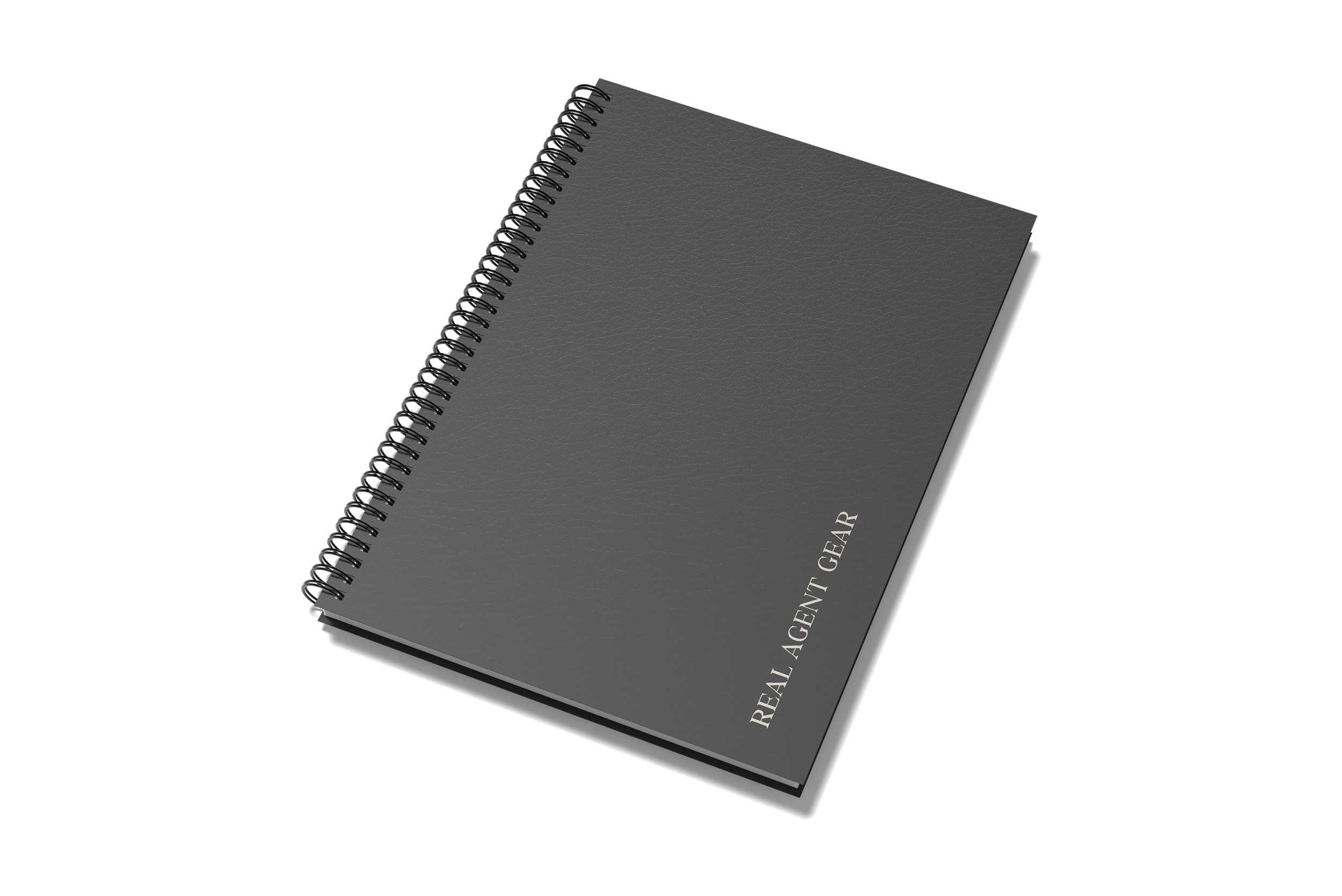 Spiral-bound black notebook titled "Real Agent Gear" with a textured cover, positioned diagonally on a black background.