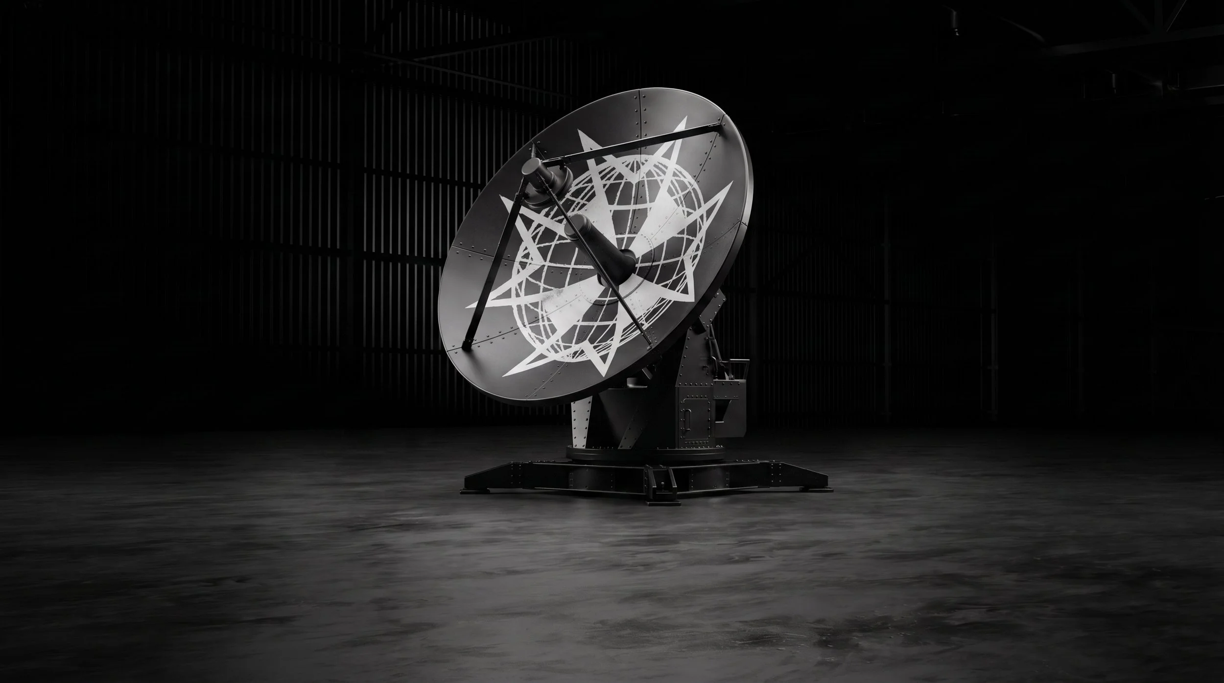 Large black satellite dish with a Navigantium logo, positioned indoors in a dark room with black walls and flooring.