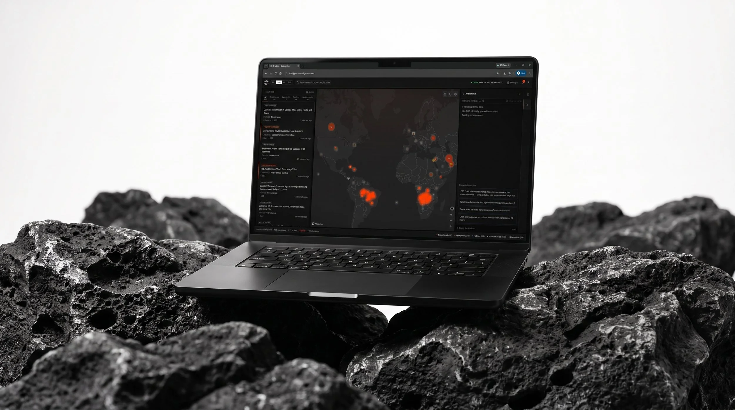 A laptop displaying a dark-themed map and data on a rocky surface with a plain white background.