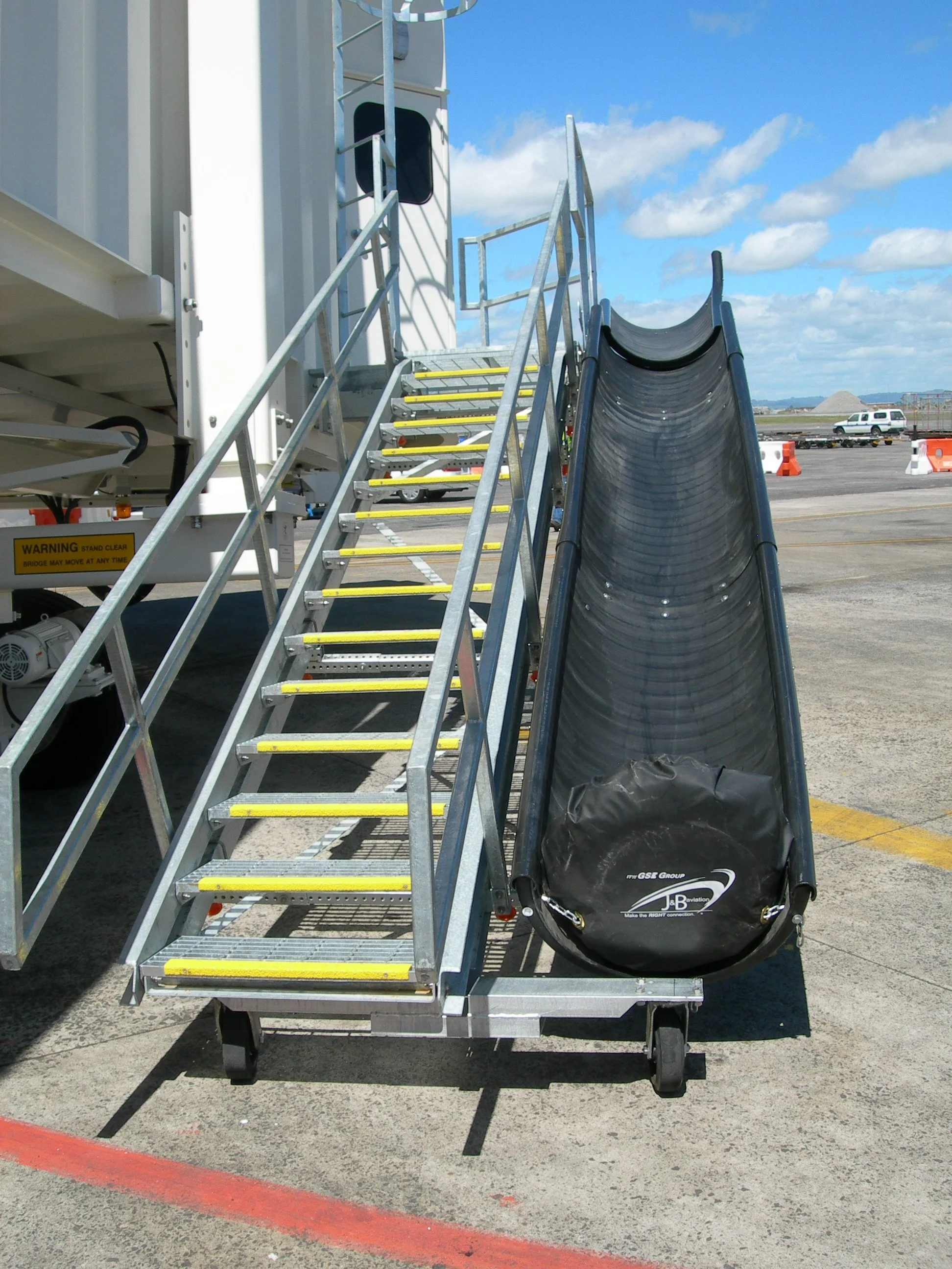 Stairs likely connected to a boarding bridge, with a baggage chute down the right-hand side.