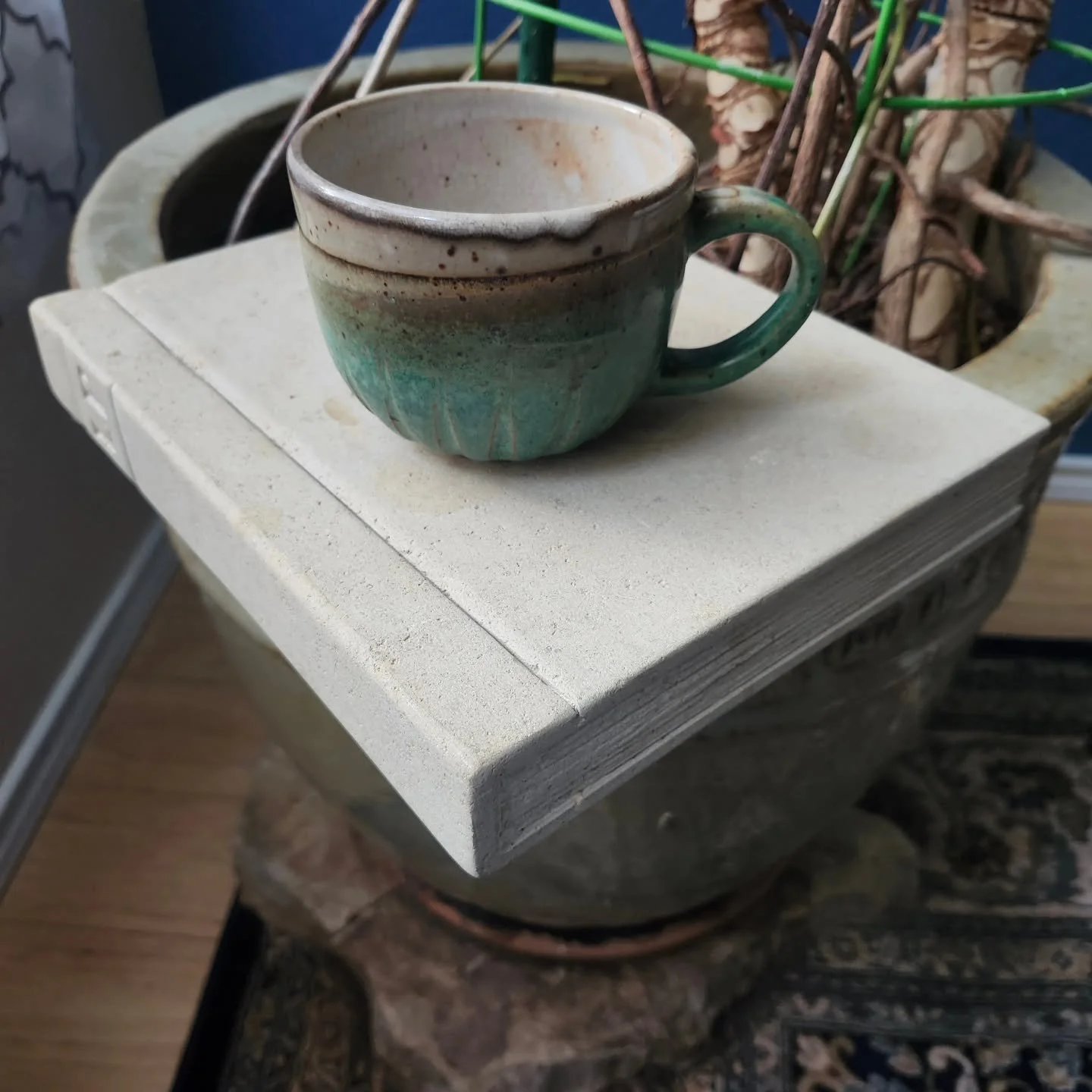 Everyone should have a limestone "book" side table for morning coffee.