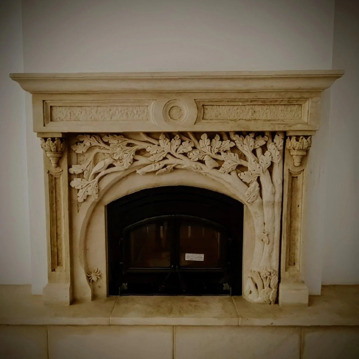 Surround installed in private residence.
Hand-crafted Cordova Cream limestone fireplace surround carved using hammer and chisels.