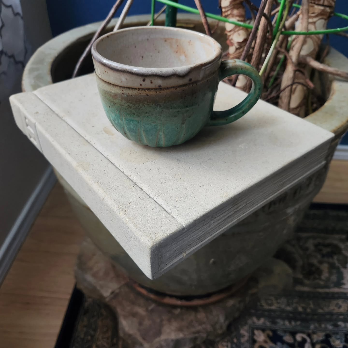 Everyone should have a limestone "book" side table for morning coffee.