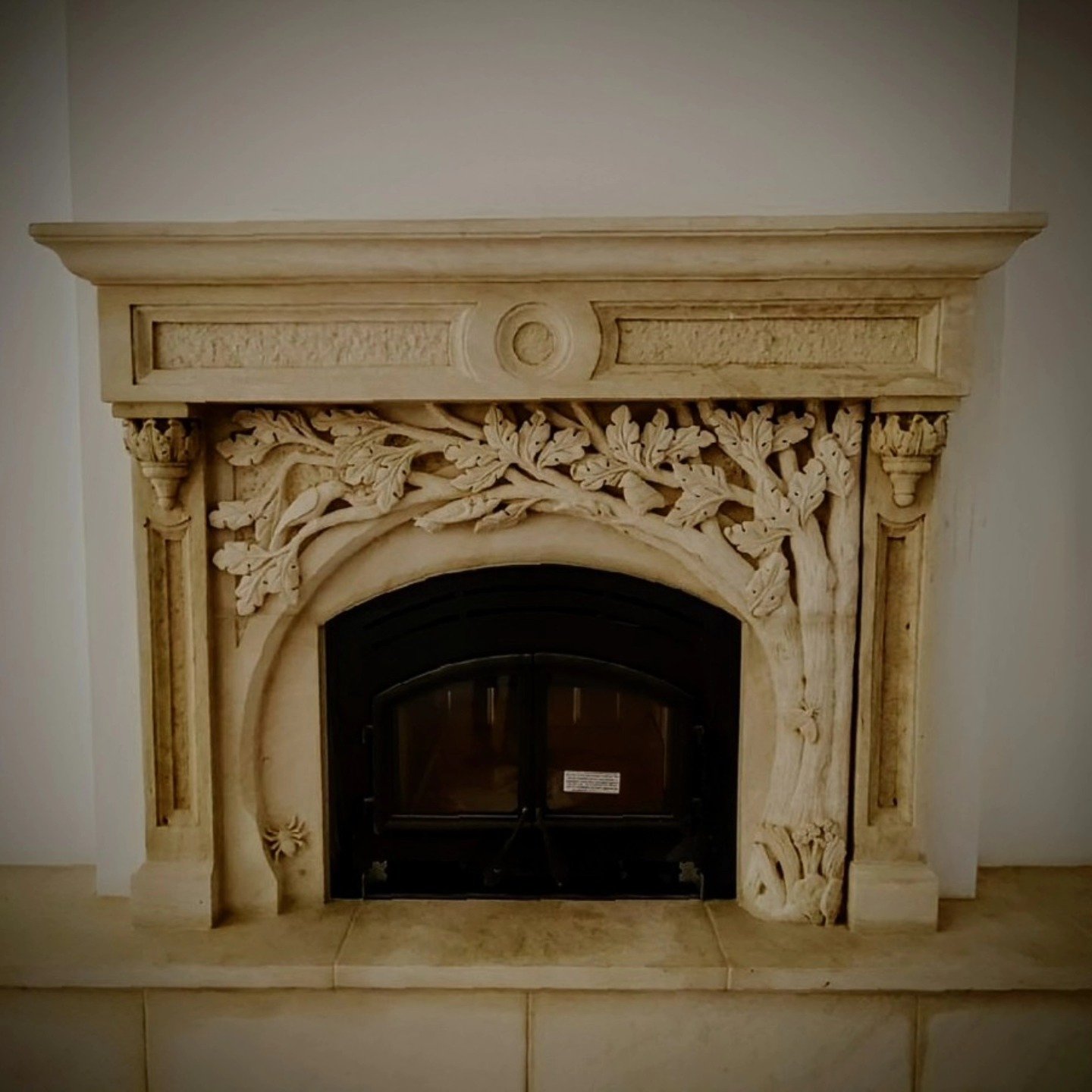 Surround installed in private residence.
Hand-crafted Cordova Cream limestone fireplace surround carved using hammer and chisels.