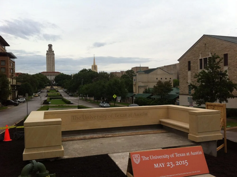 Newly installed entryway sign with inscription reading "The University of Texas at Austin." 