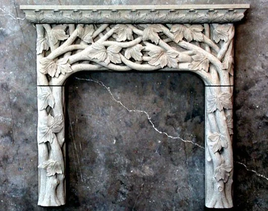 Ornate carved stone fireplace mantel with floral and leaf patterns