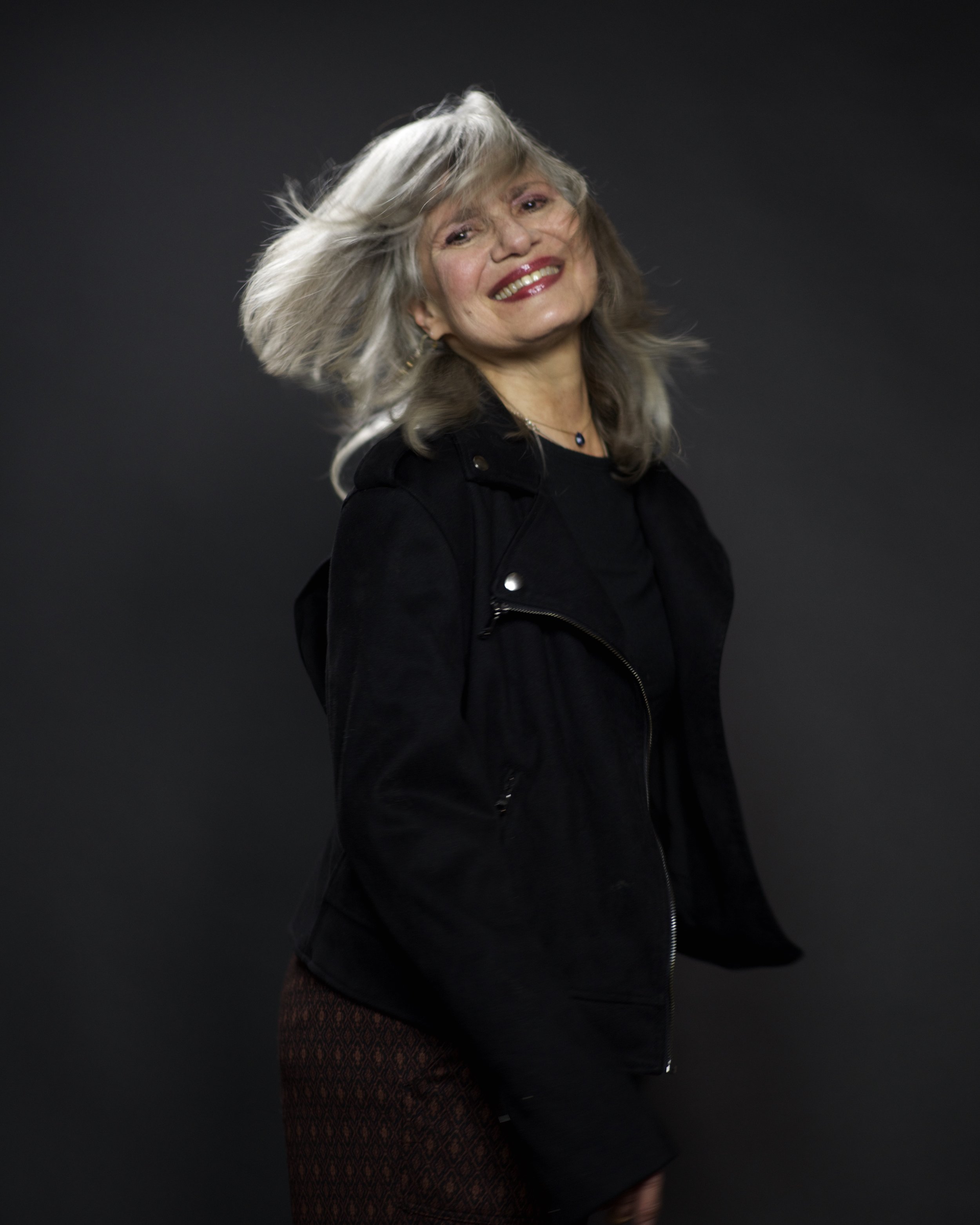 Woman in her 60s (Betsy Mars) smiling and tossing her hair