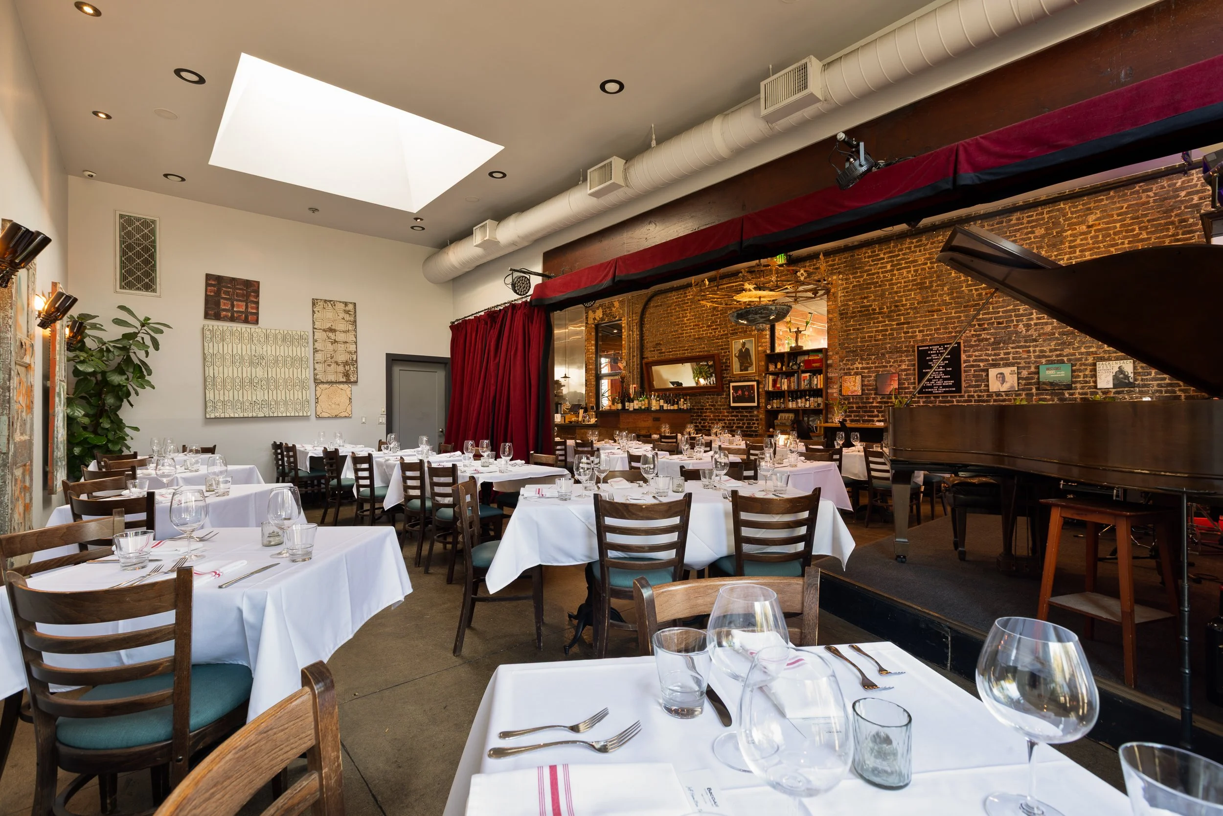 Bacchus dining room set for dinner under the skylight