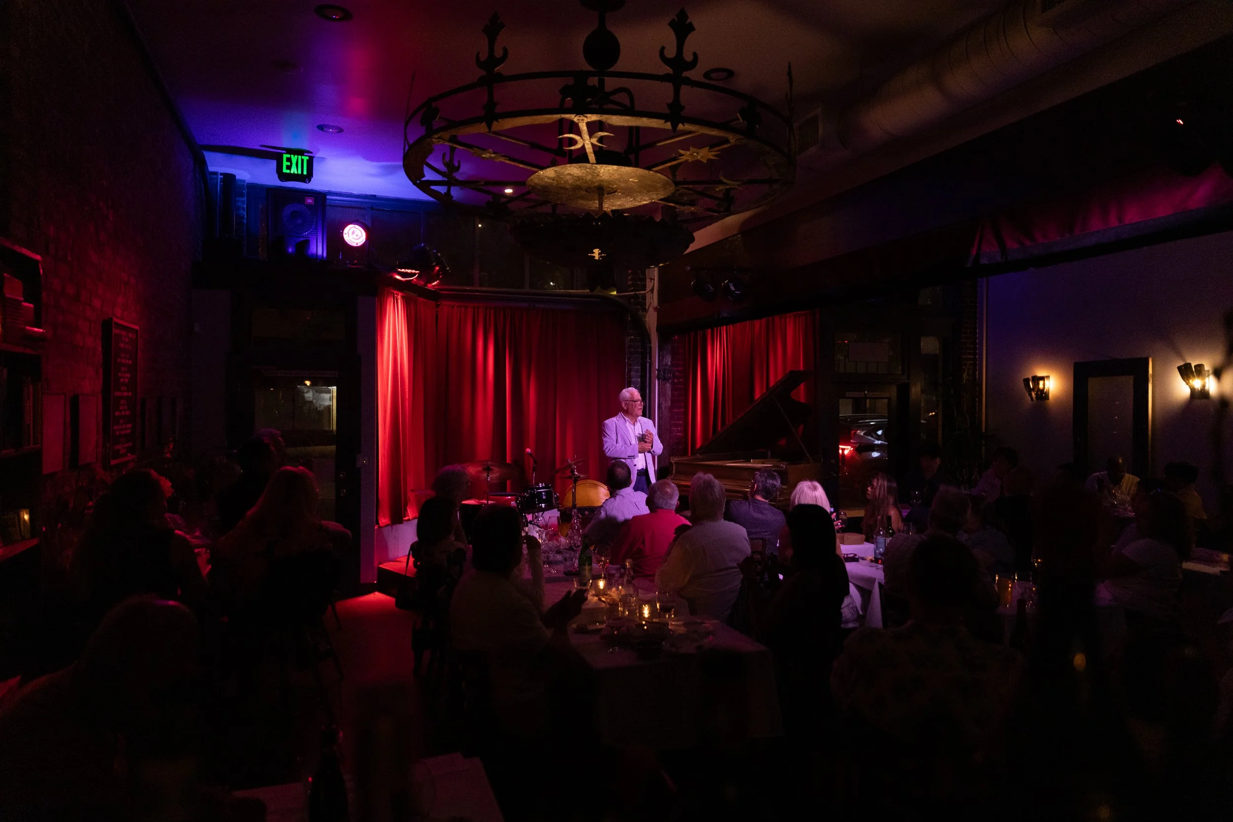 Jazz band playing in front of the red curtains at Bacchus Kitchen + Wine Bar