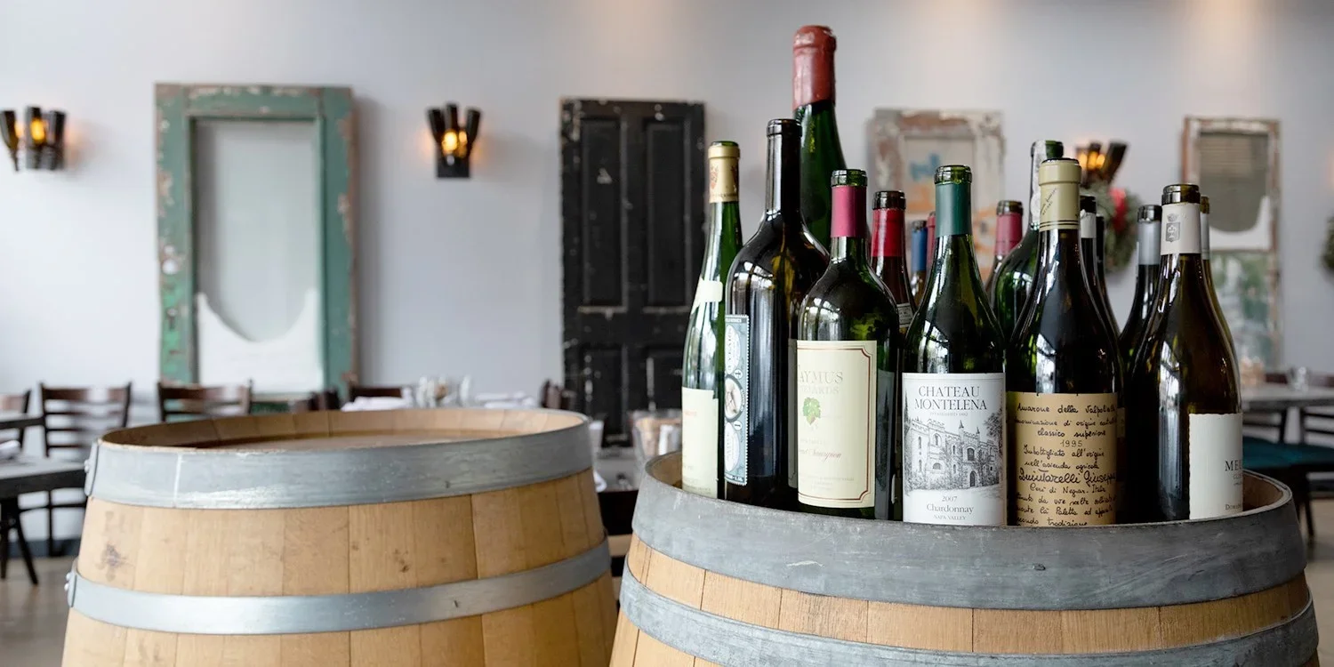 wine bottles on a barrel.webp