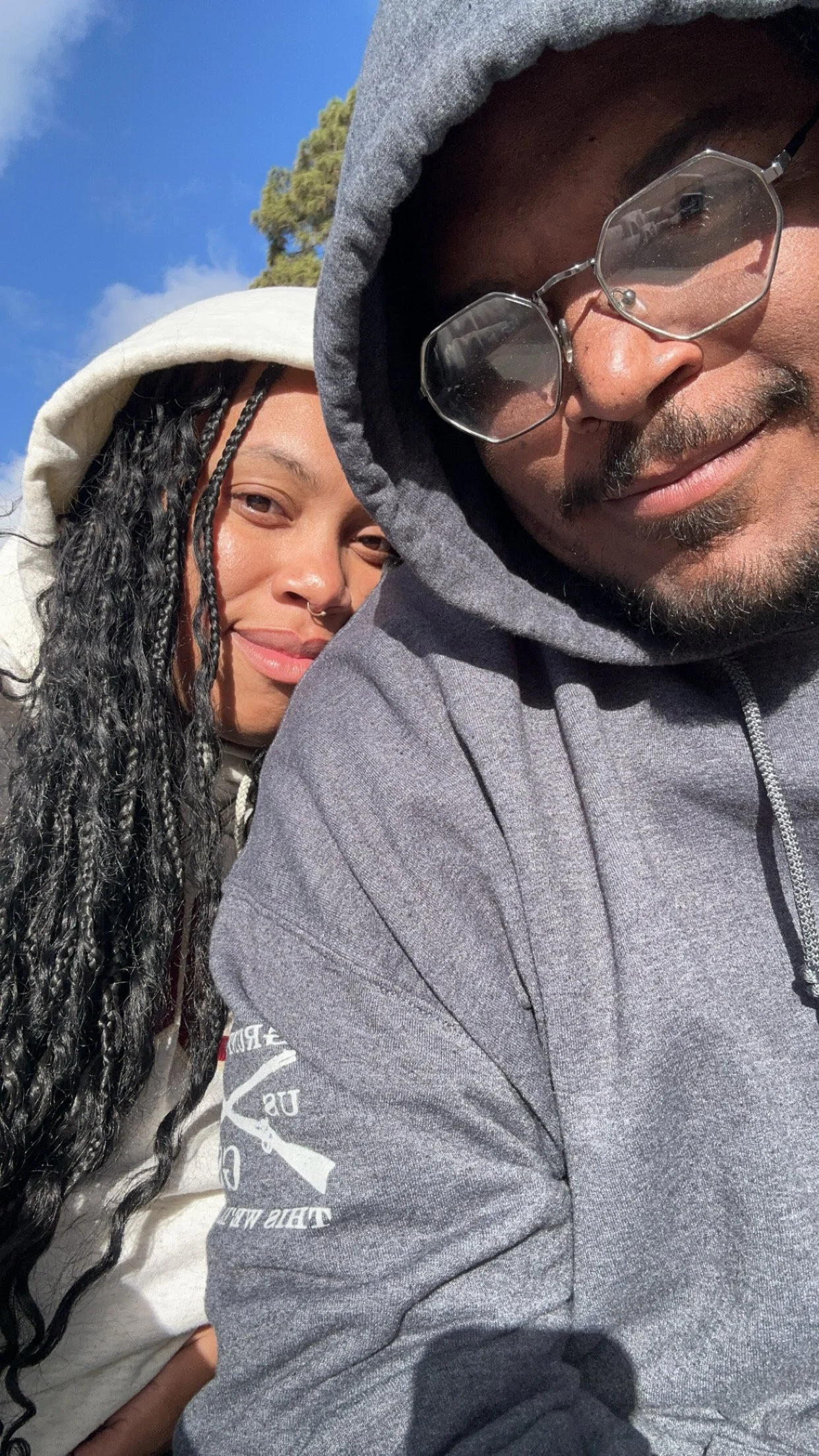 Jazzmin and sean both close wearing grunt style hoodies smiling