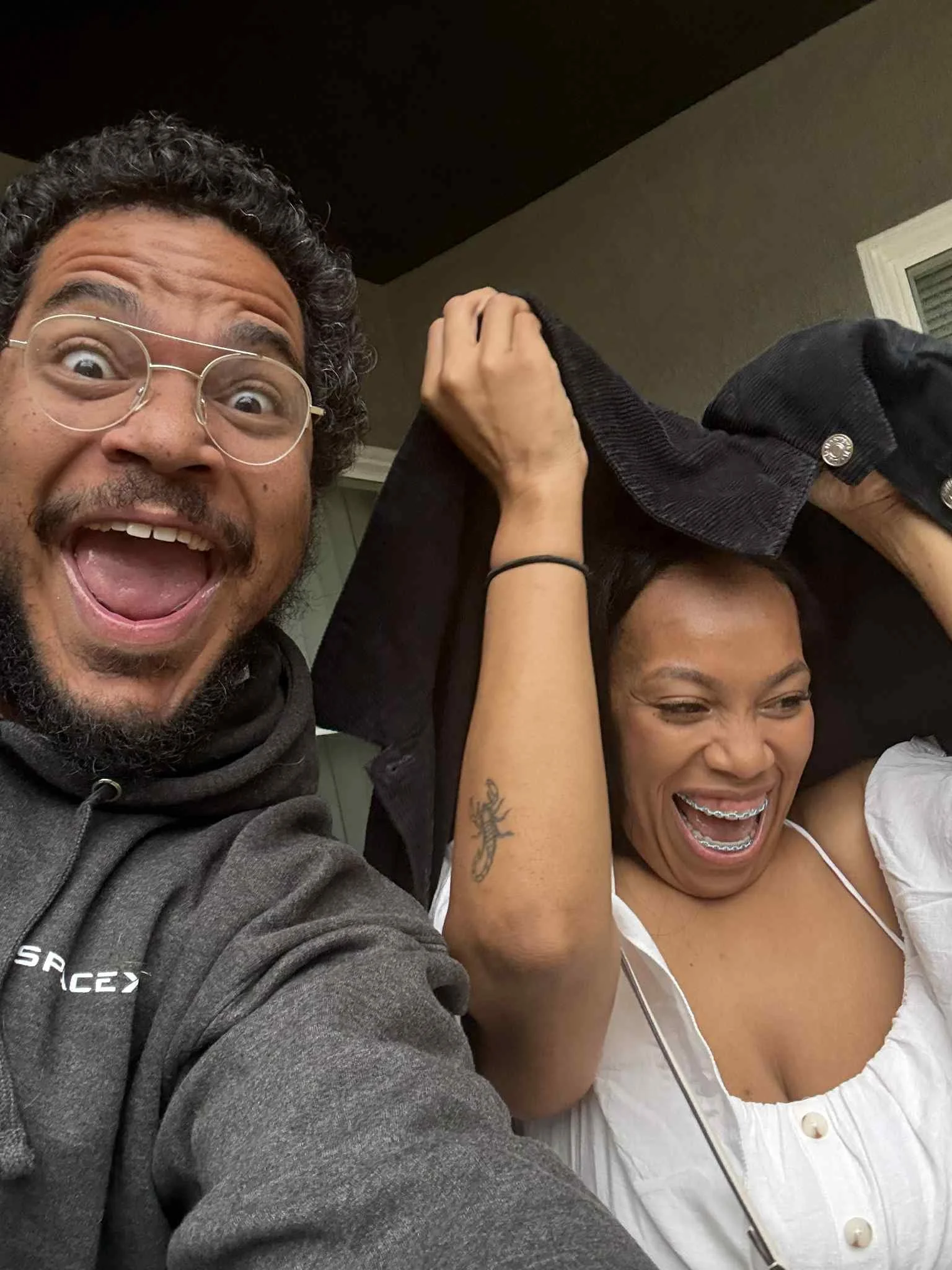 Jazzmin and Sean smiling together for an indoor selfie