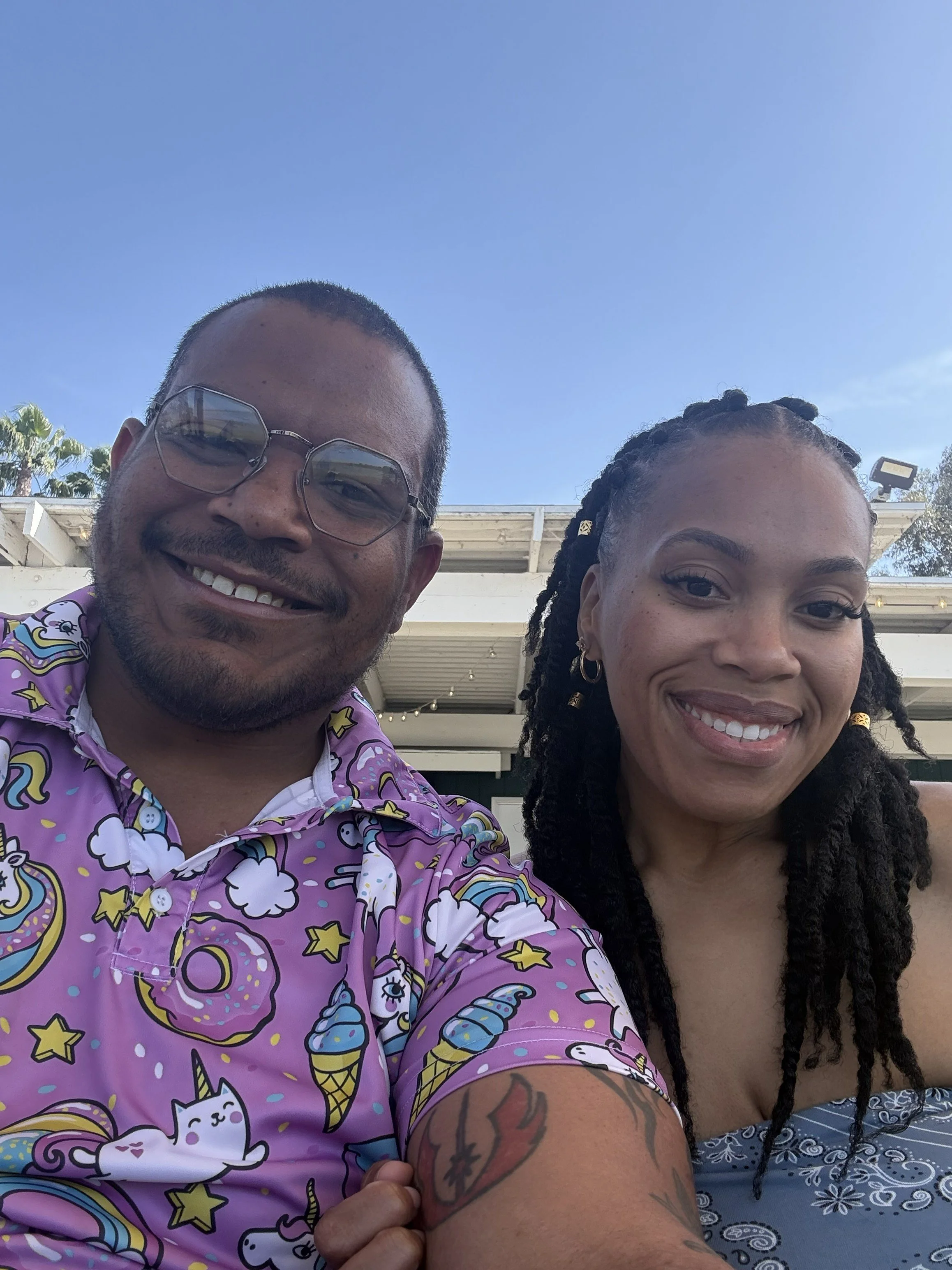 Jazzmin and Sean smiling together outdoors on a sunny day
