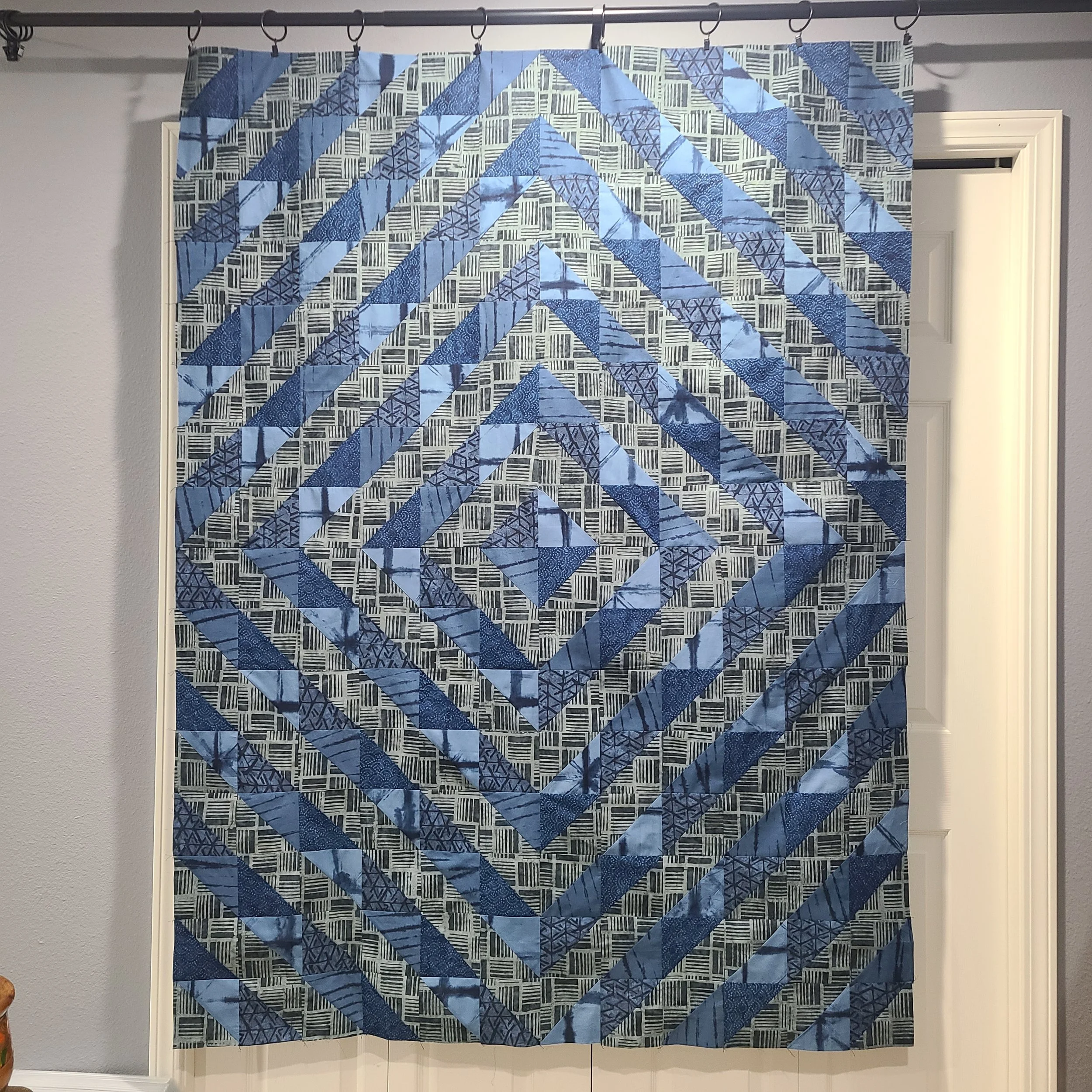 Half-square triangle quilt in muted batiks