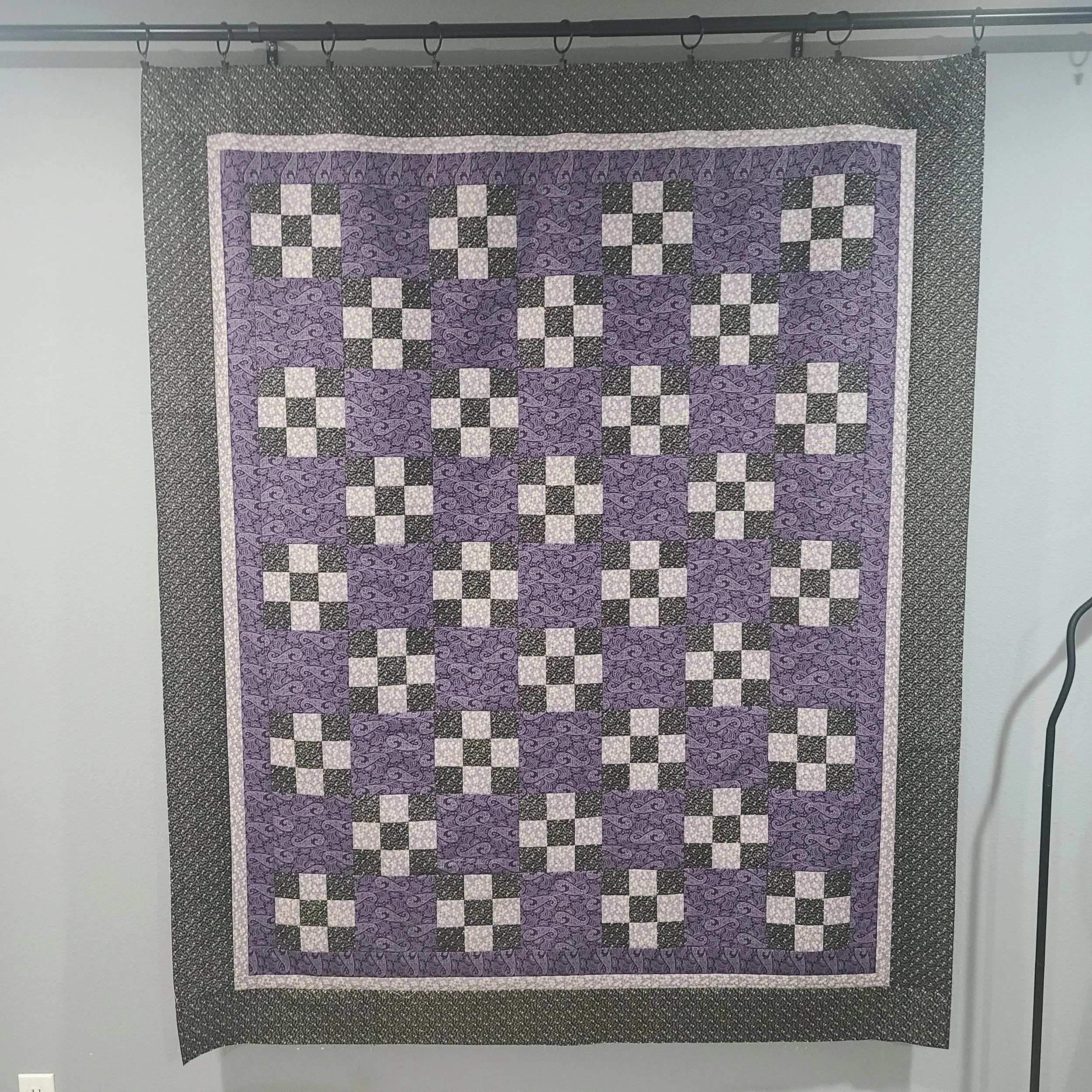Vintage-look throw size quilt in purple